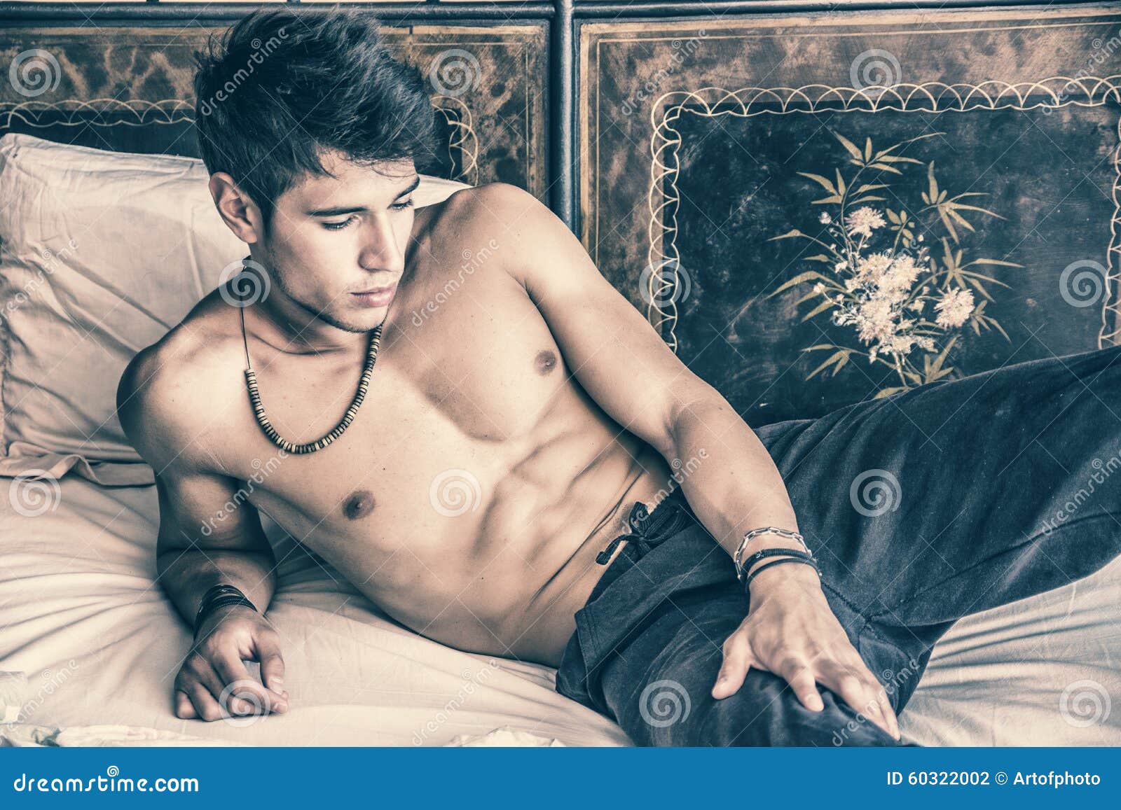 Shirtless Male Model Lying Alone On His Bed Stock Photo Image