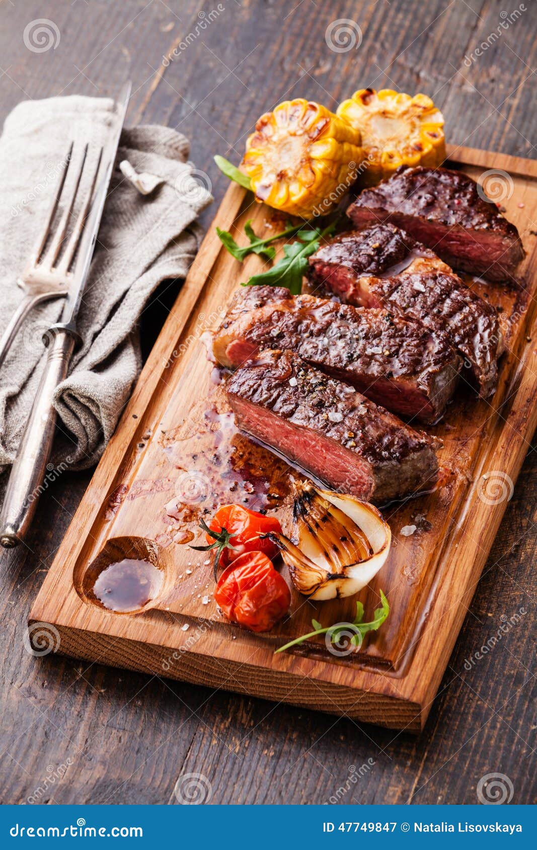  with corn and cherry tomatoes on cutting board on wooden background