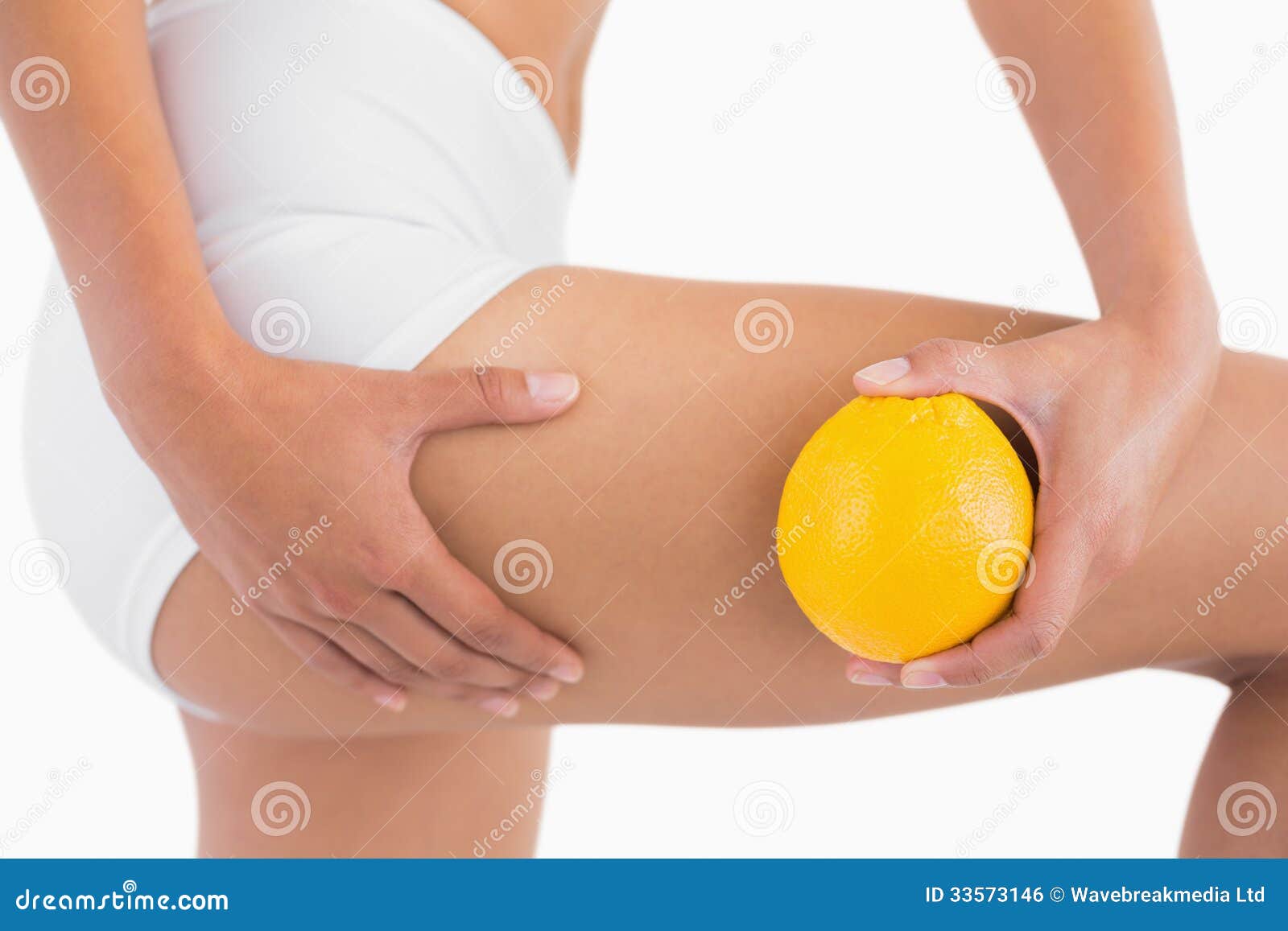 slim-woman-squeezing-cellulite-skin-thigh-as-holds-orange-white-background-33573146.jpg