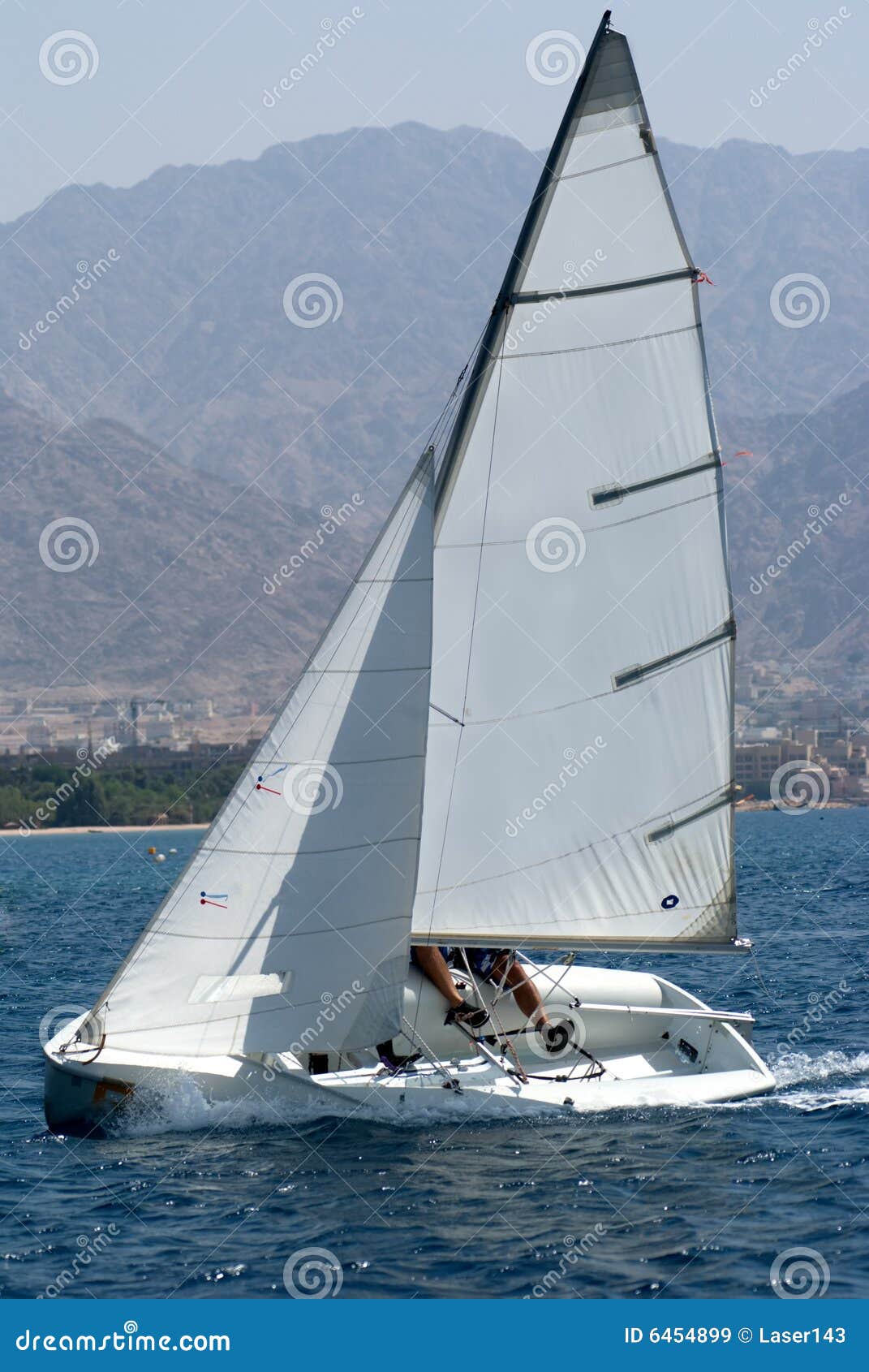 Team sailing on a small sail boat.