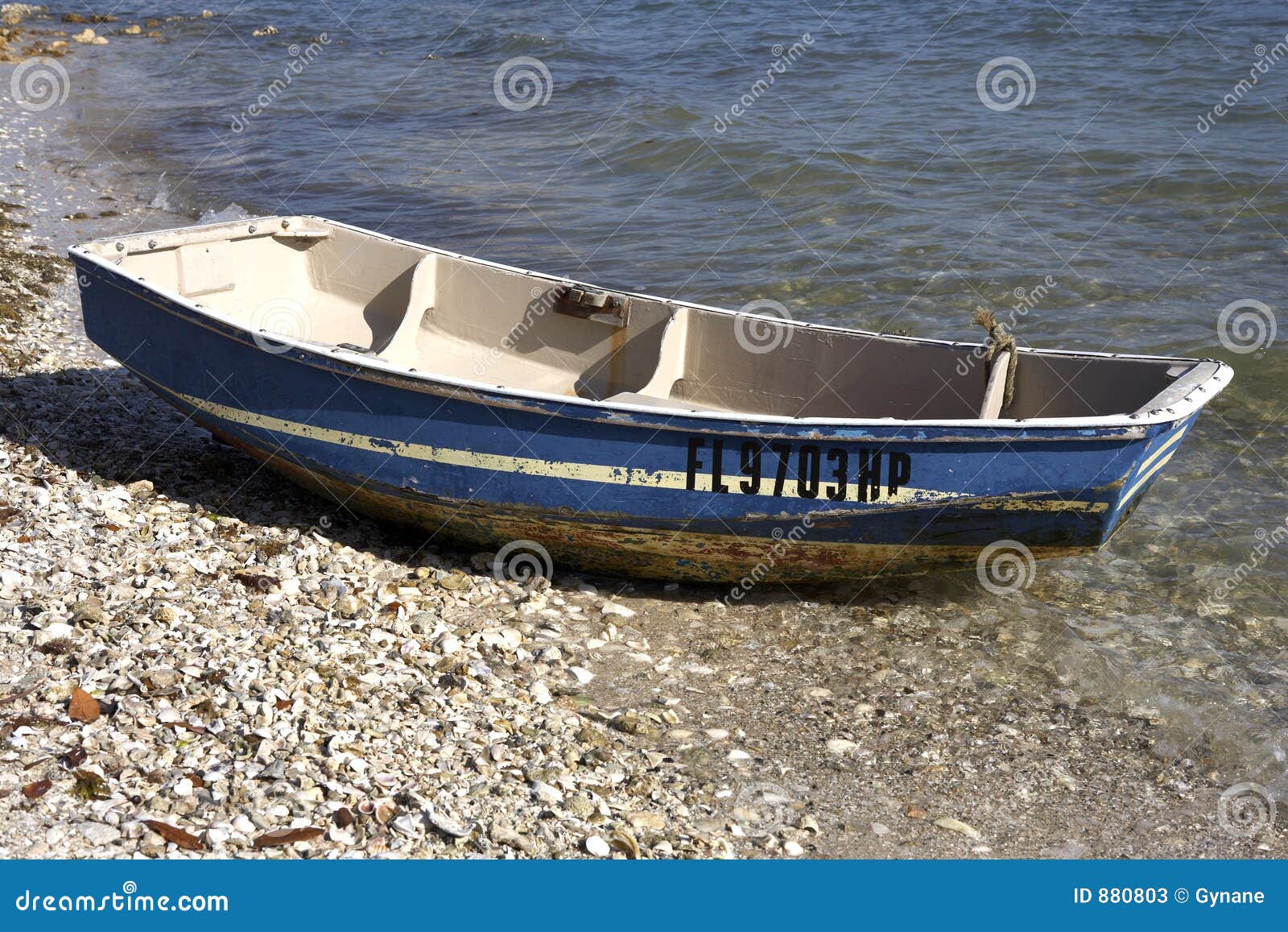 Small wooden boat on the shoreline of island park sarasota florida 