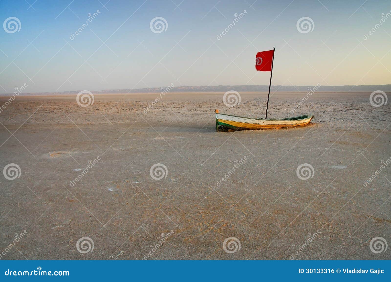 Small wooden boat at dried Chott el Jerid - large endorheic salt lake 