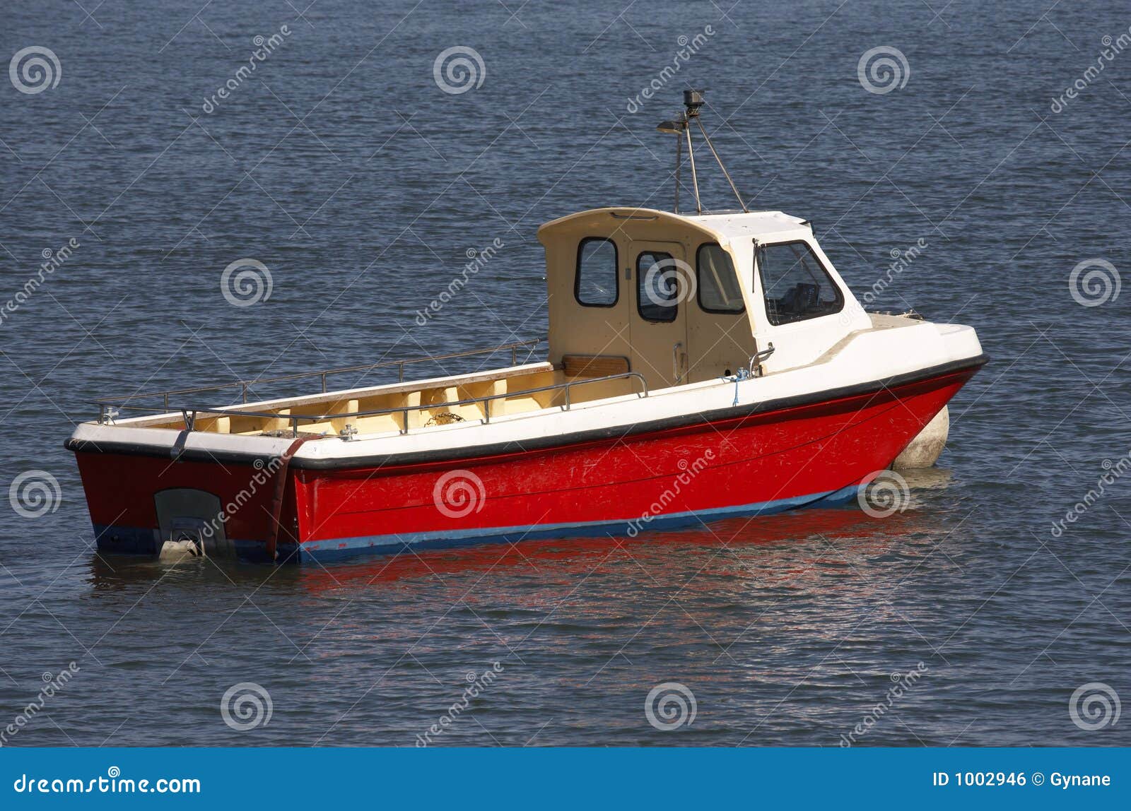Small wooden motor boat tethered on the river dart dartmouth devon 