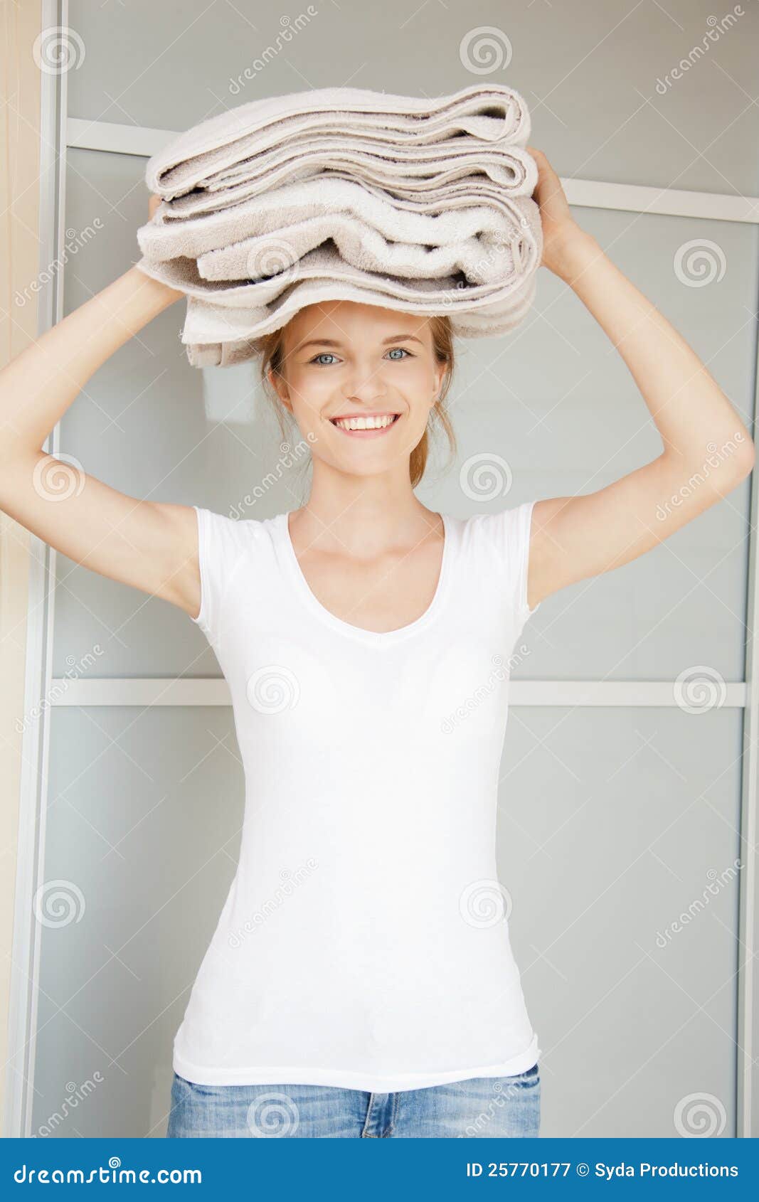 Picture of smiling teenage girl with towels.