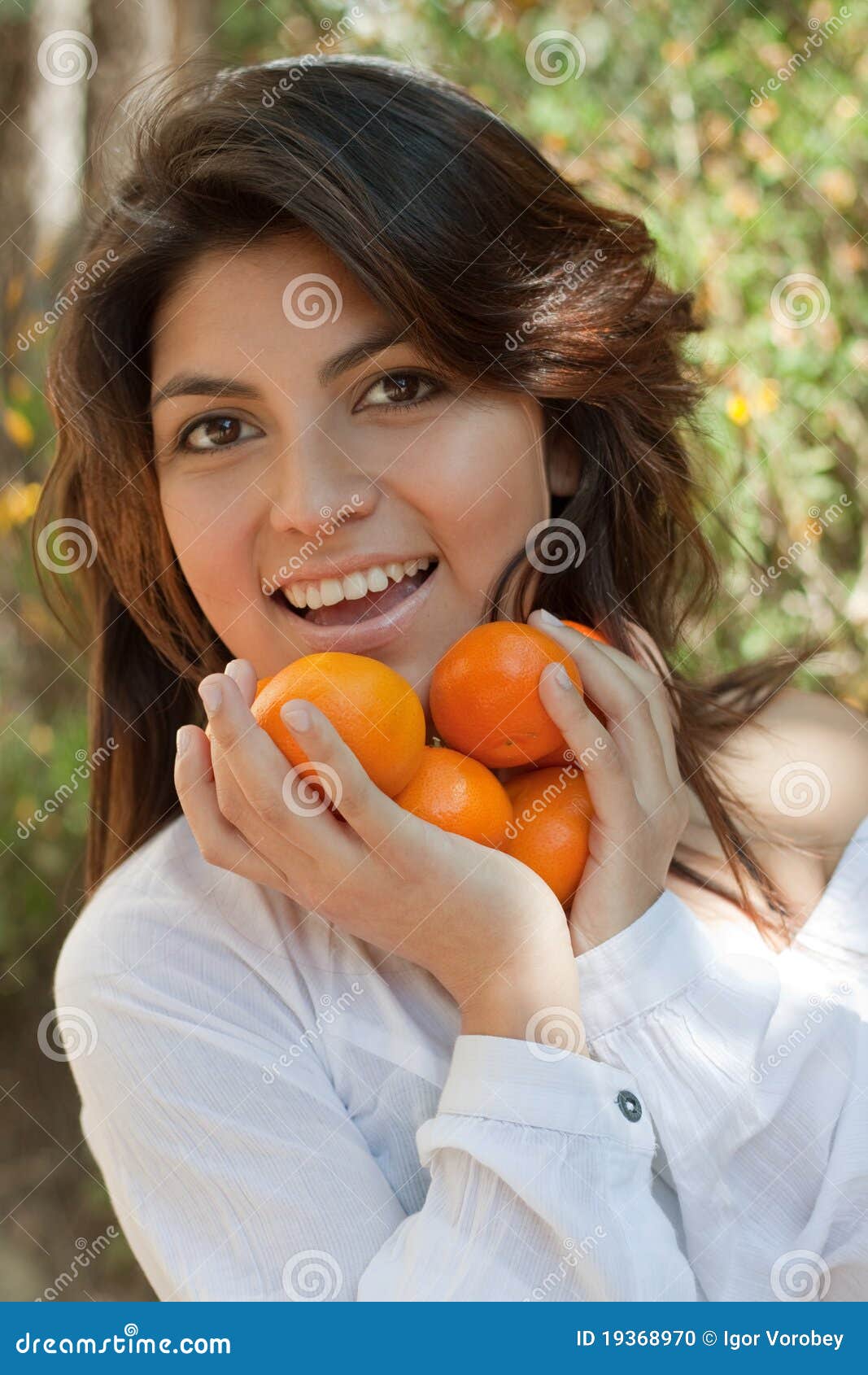 Smiling Young Spanish Girl With A Tangerine Stock Photo ...