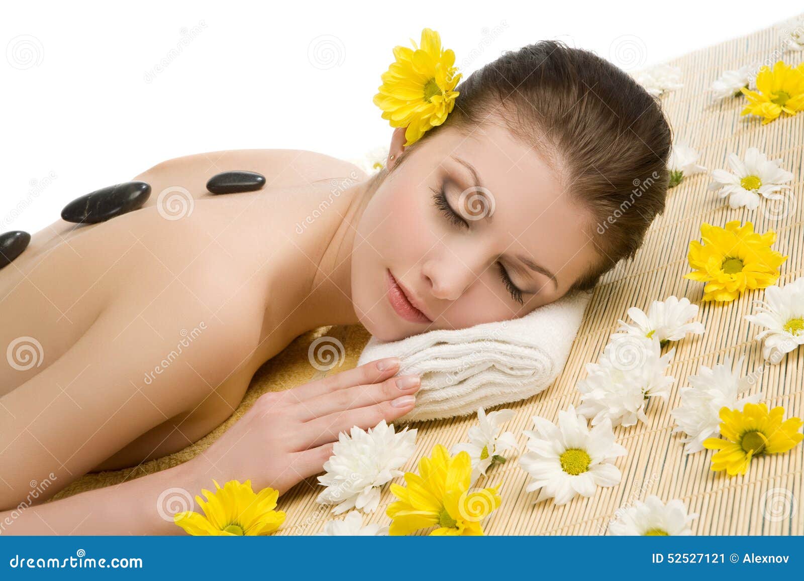 Spa salon: woman relaxing on mat with flowers and stones - spa-salon-woman-relaxing-mat-flowers-stones-beautiful-young-lying-down-straw-eyes-closed-52527121