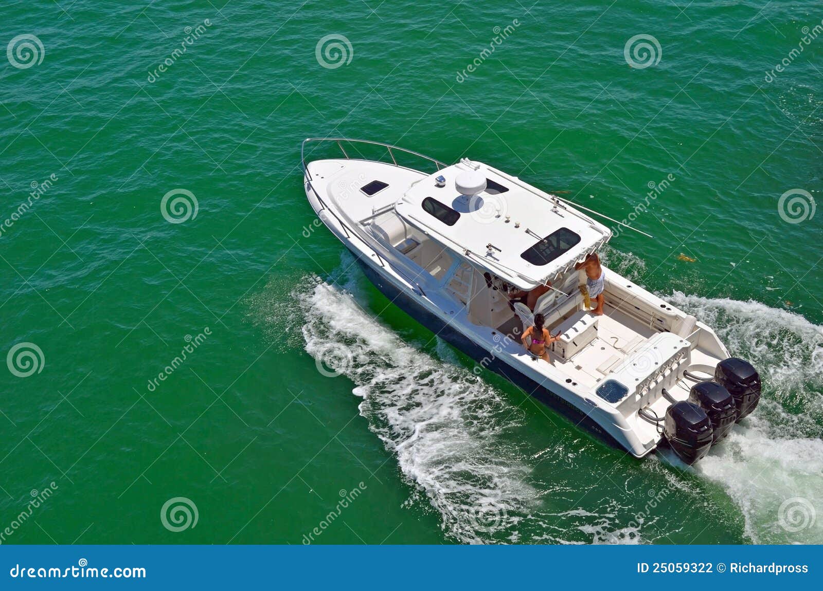 Angled overhead view of a sport fishing boat cruising the florida 