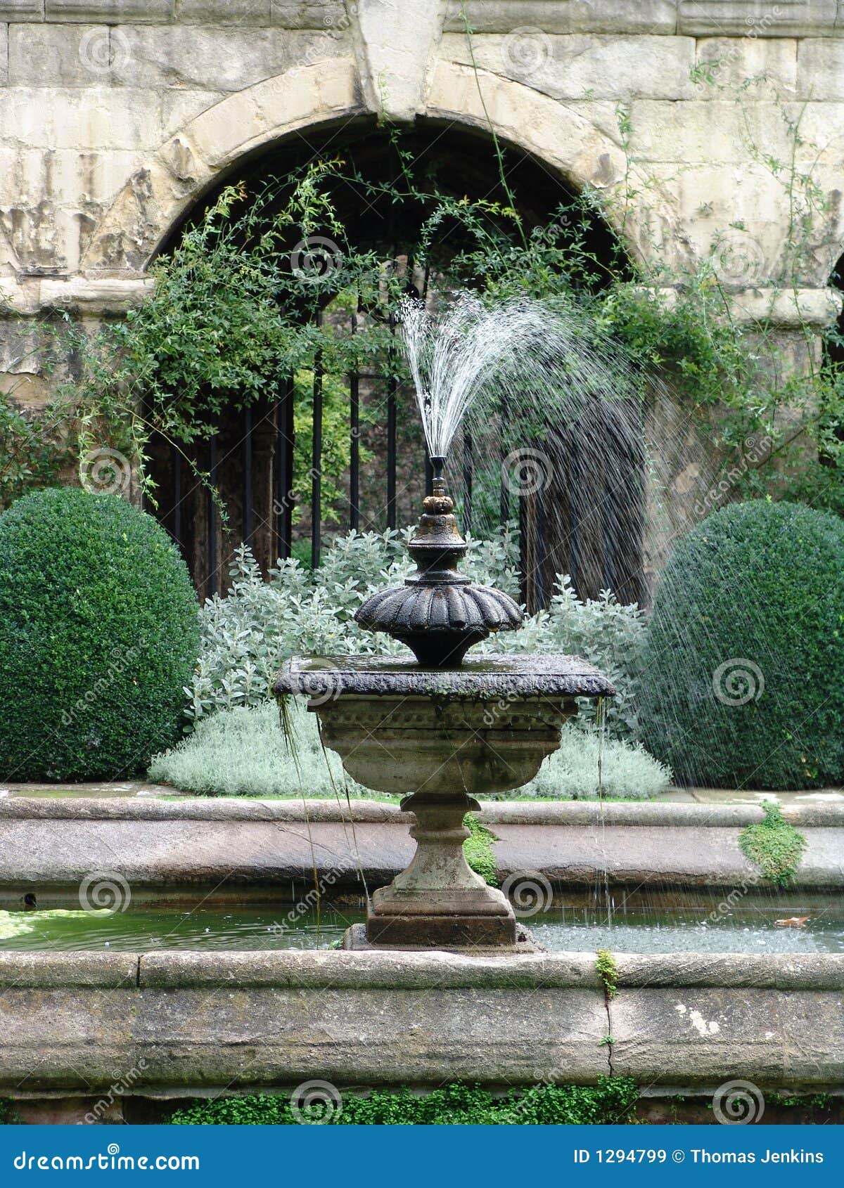 working fountain in classical renaissance walled courtyard garden 