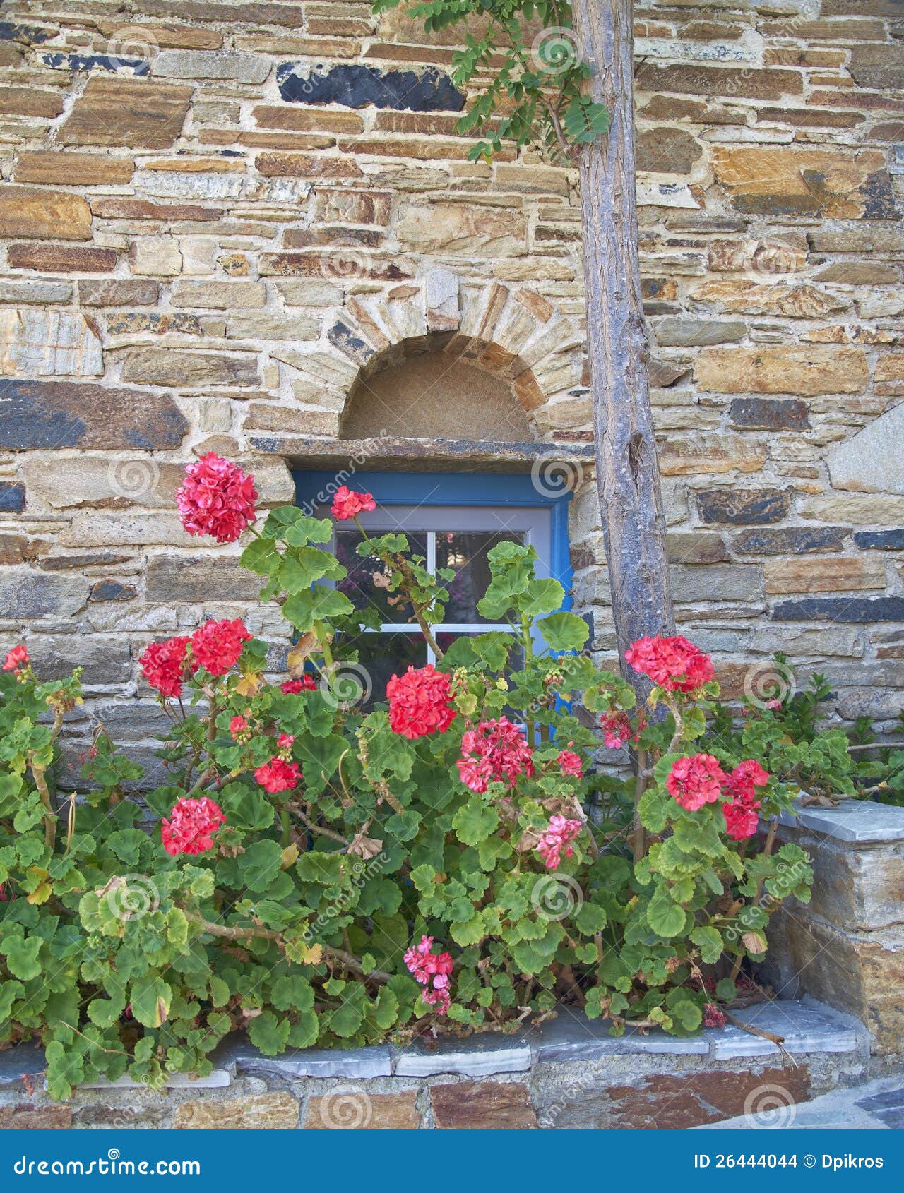 Stone Wall With Blue Window And Flowers Stock Images  Image: 26444044