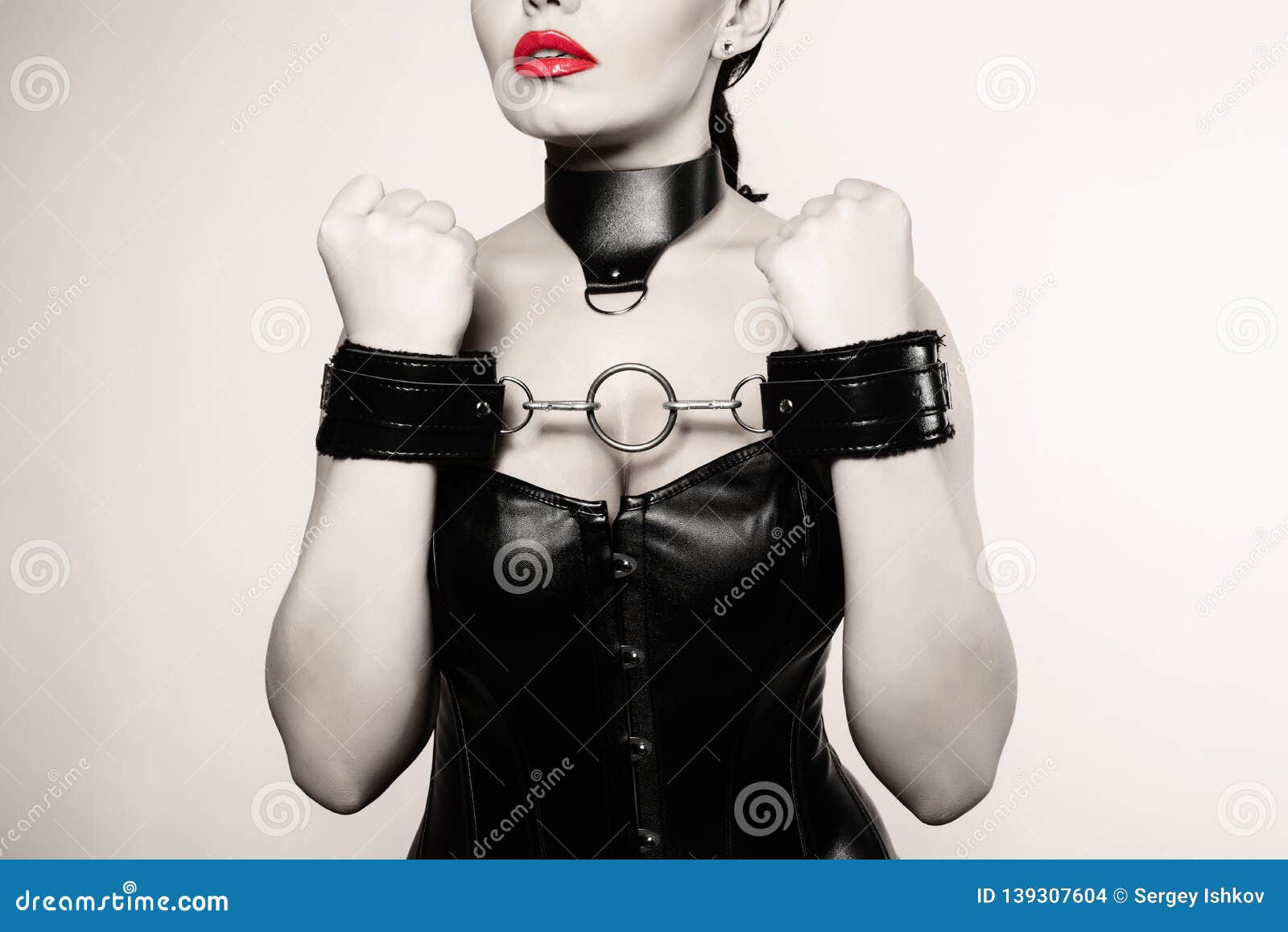 Submissive Girl In Leather Black Corset Handcuffs And Collar Waiting