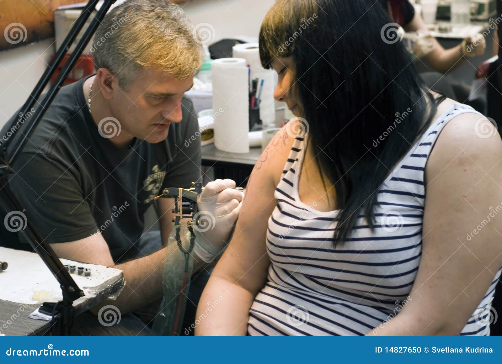 Editorial Image: Tattoo artist at work at St.Petersburg Tattoo Fest