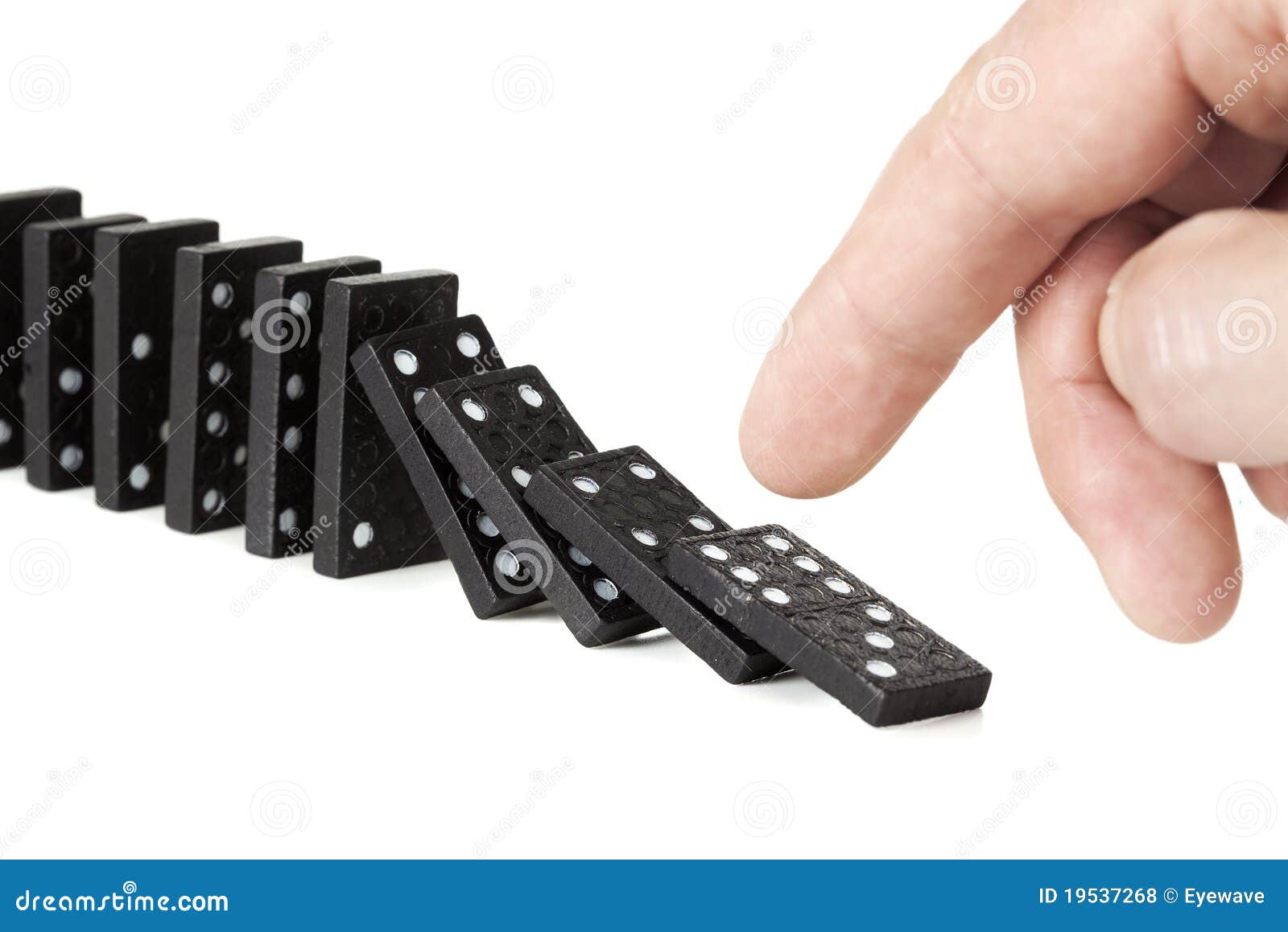 Toppling A Row Of Domino Pieces Toppling A Row Of Domino Pieces Royalty Free Stock Photos
