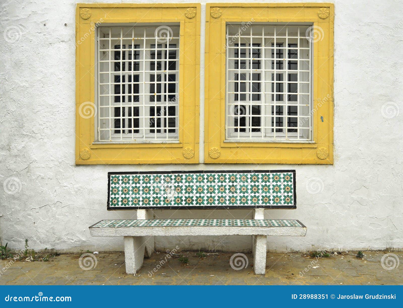 Traditional Tunisian bench under a window.