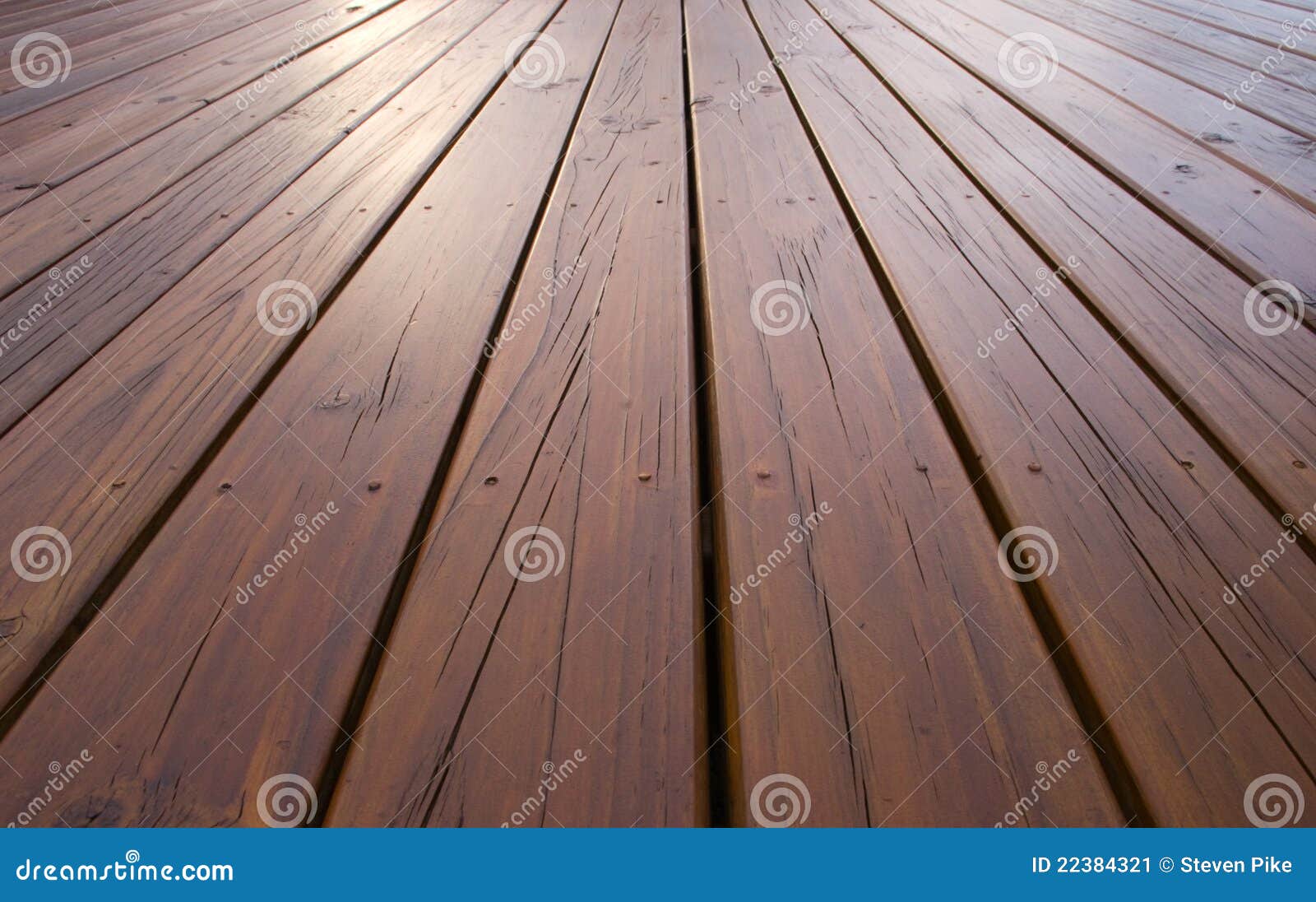 Planks of pine decking treated with deck oil.