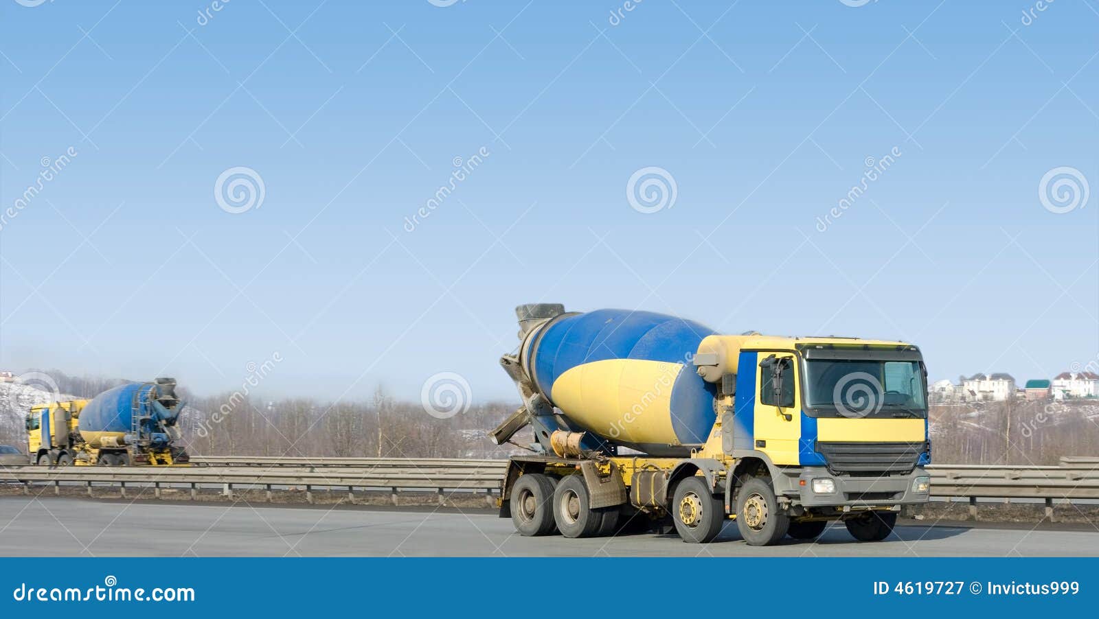  identical yellow concrete mixer trucks drive in different directions