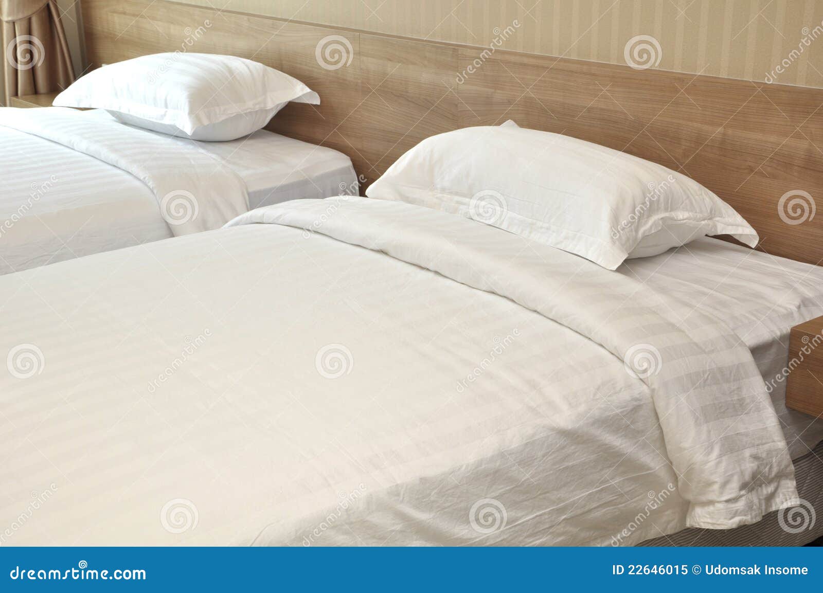 Two white bed cover in the bed room.