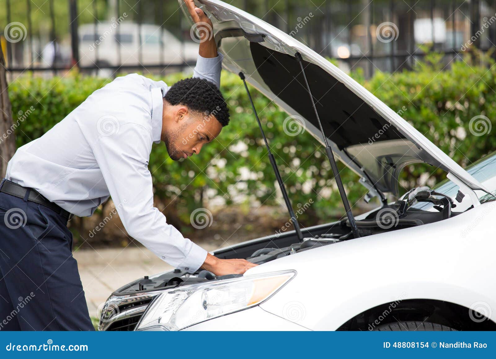  green trees outside background. Car won't start, dead battery