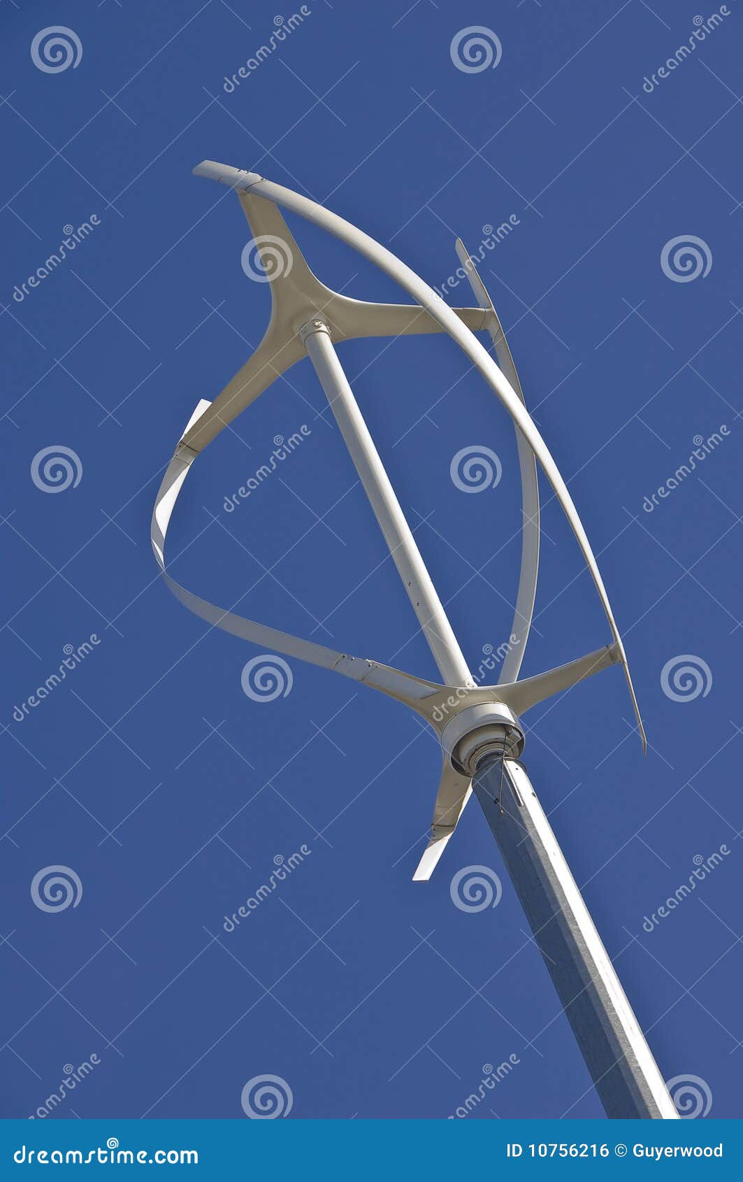  diagonal view of vertical axis wind turbine against a clear blue sky