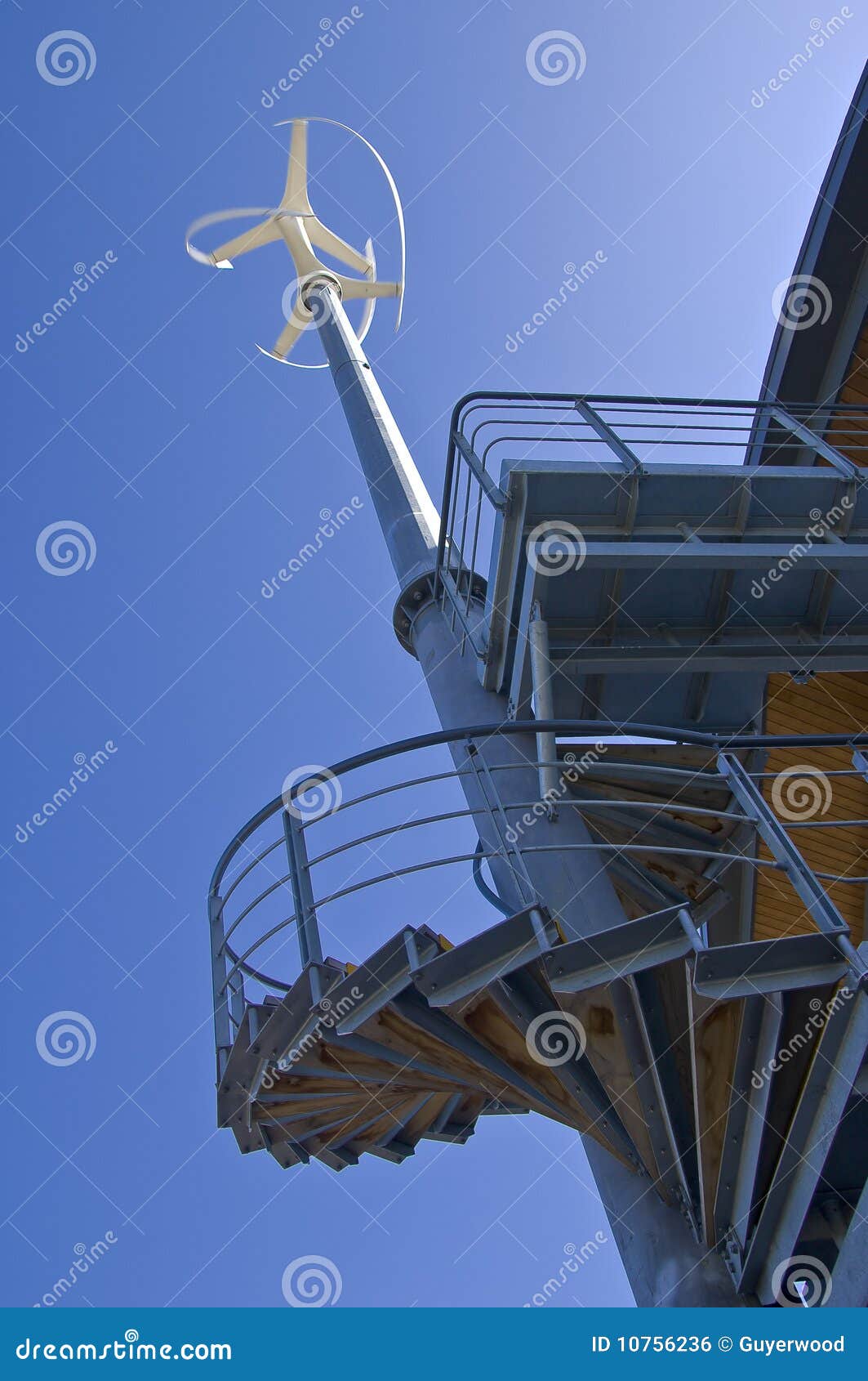 Low angle view of vertical axis wind turbine attached to building 