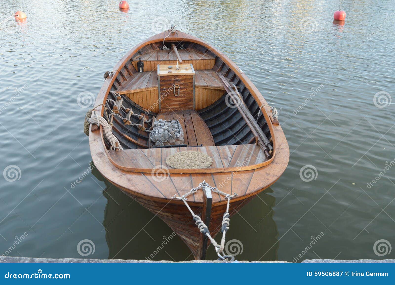 Small vintage wooden motor boat near the city embankment.