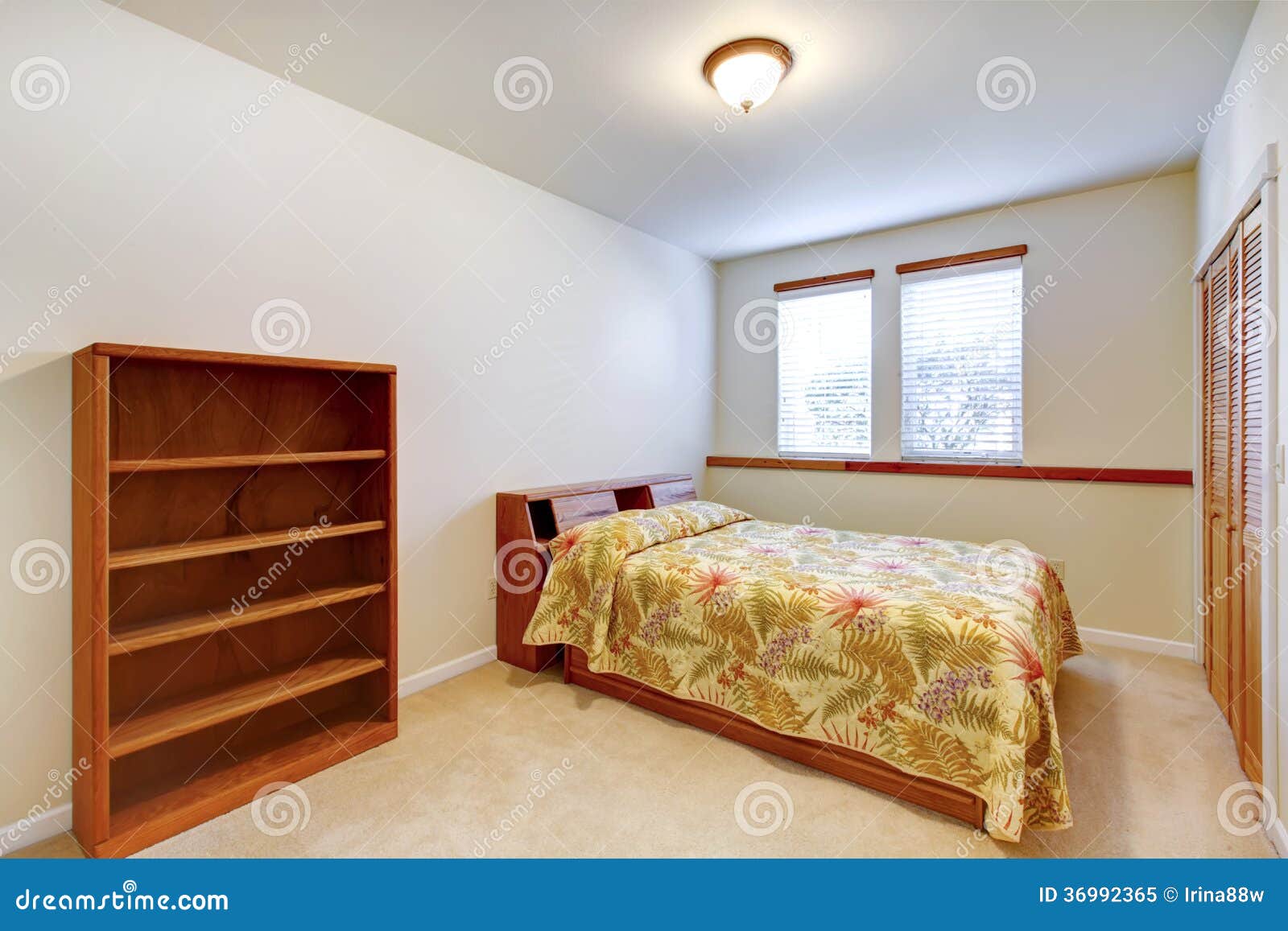 Warm simple bedroom with bifold doors walk-in closet, carpet floor and 