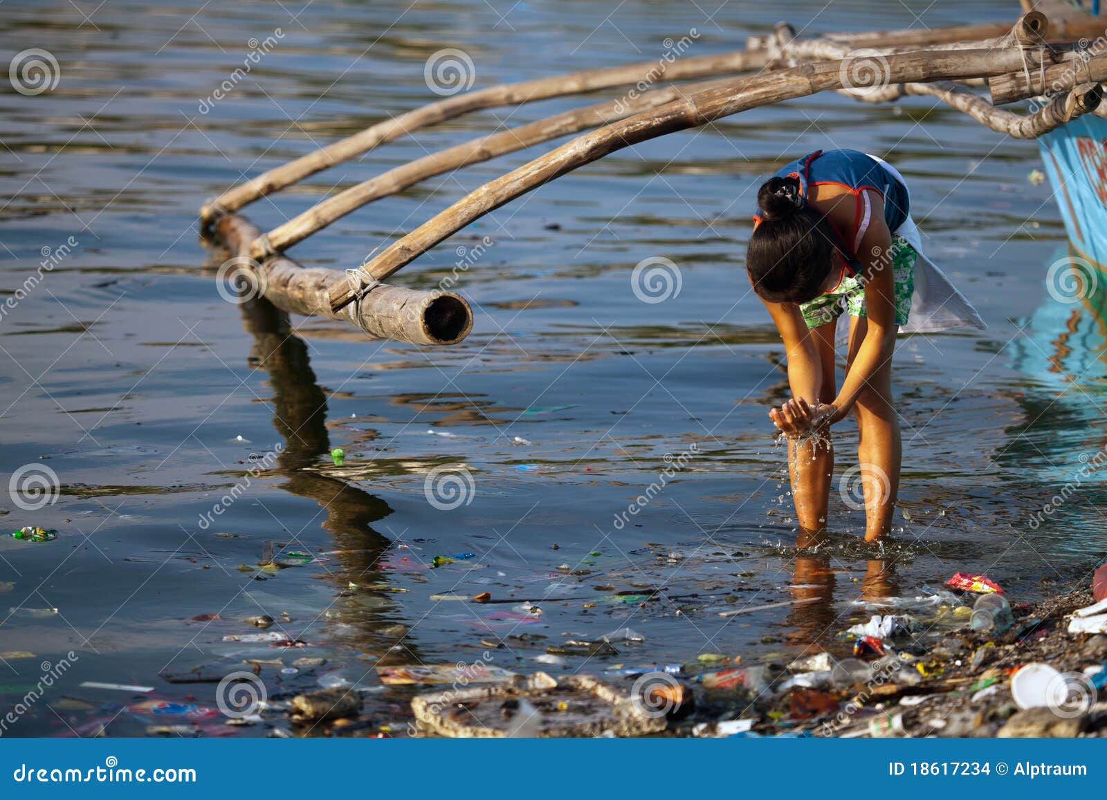  garbage can be seen floating in the foreground, local Banka boat in