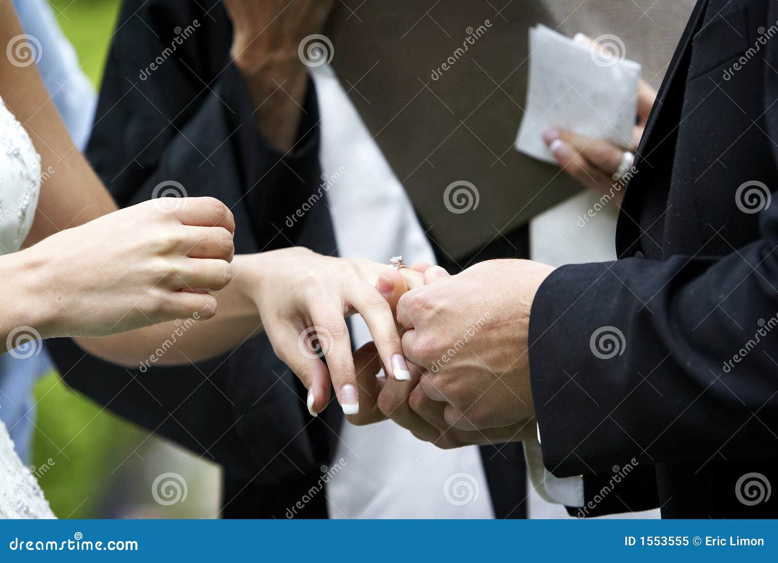 Putting the ring on the bride during a wedding ceremony.