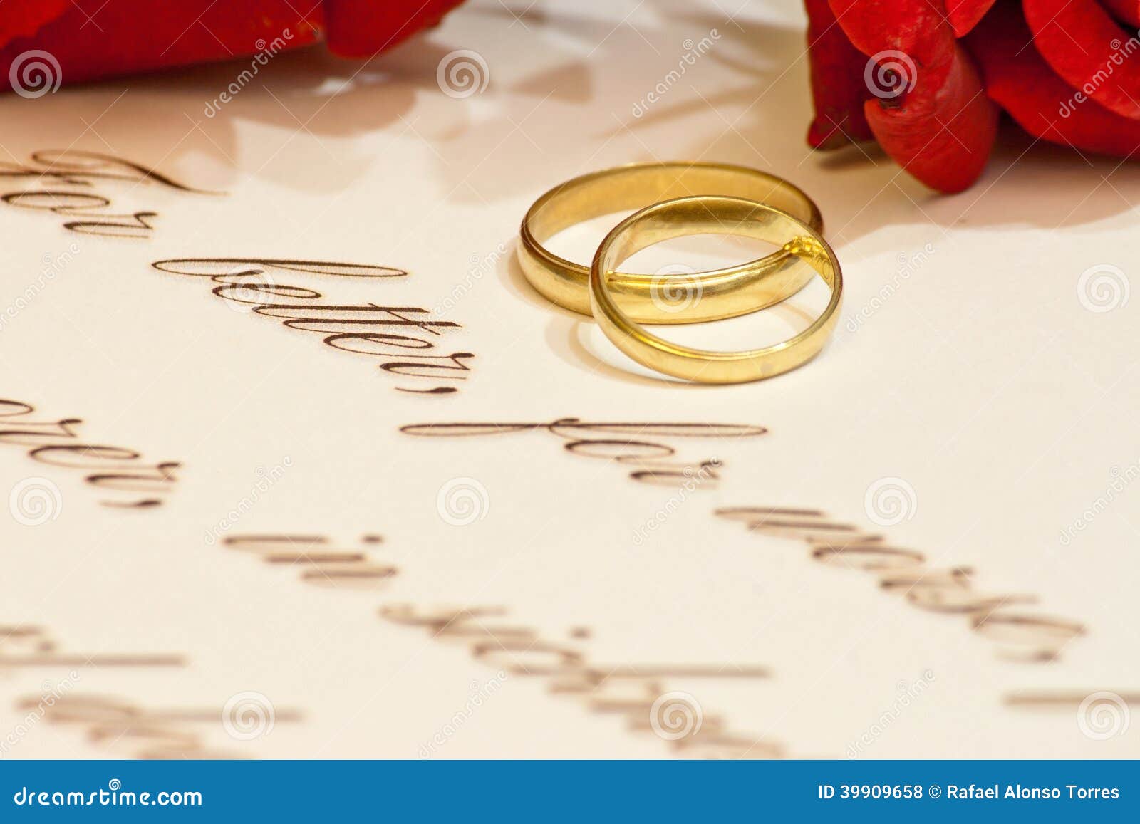 Picture of wedding rings with vows and roses.