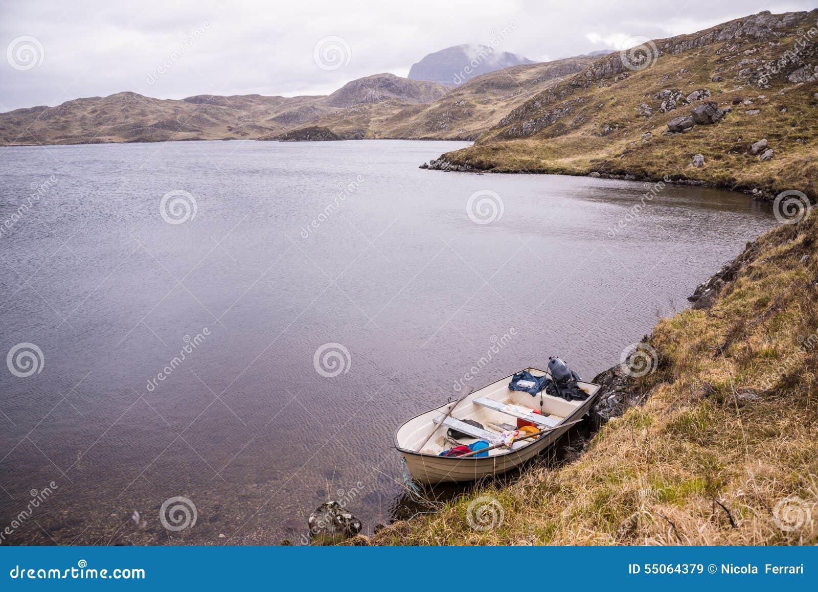 White Fishing Boat Near The Shore Of A Wild Loch Stock Photo - Image ...