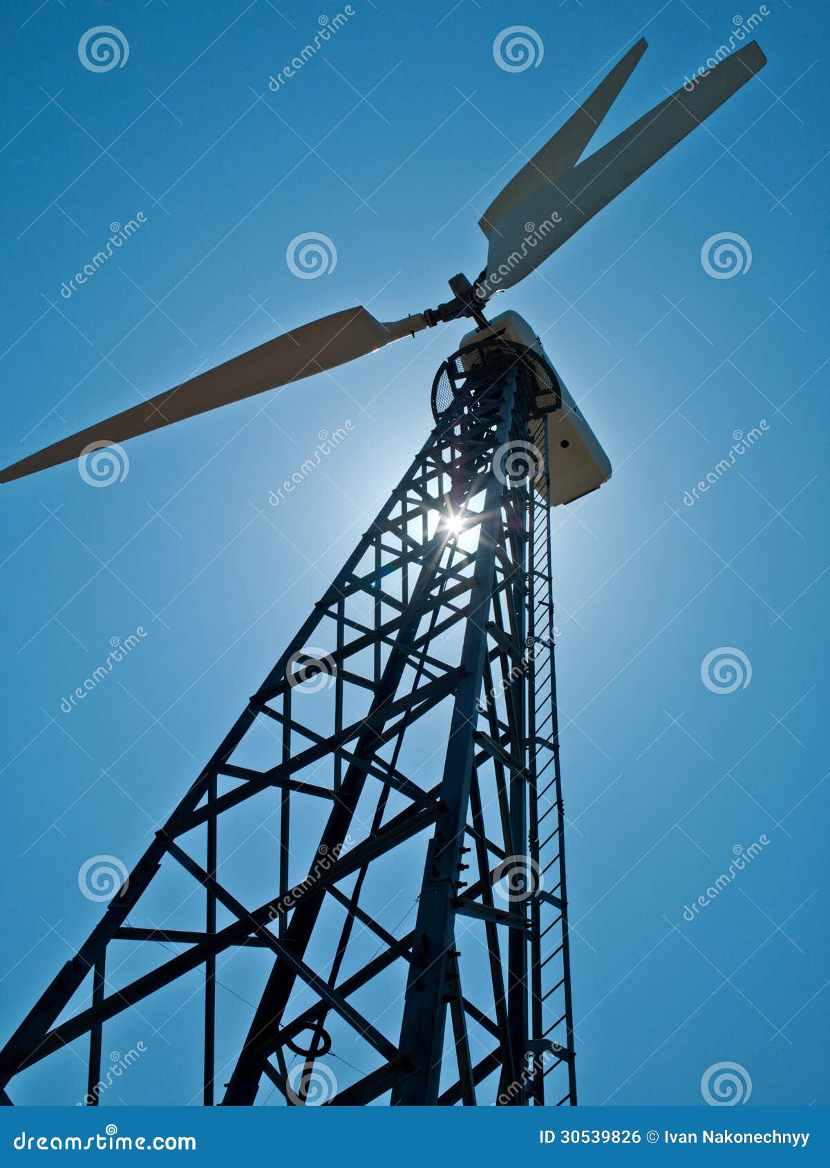 Photo in the nature of a large wind turbine generates electricity.