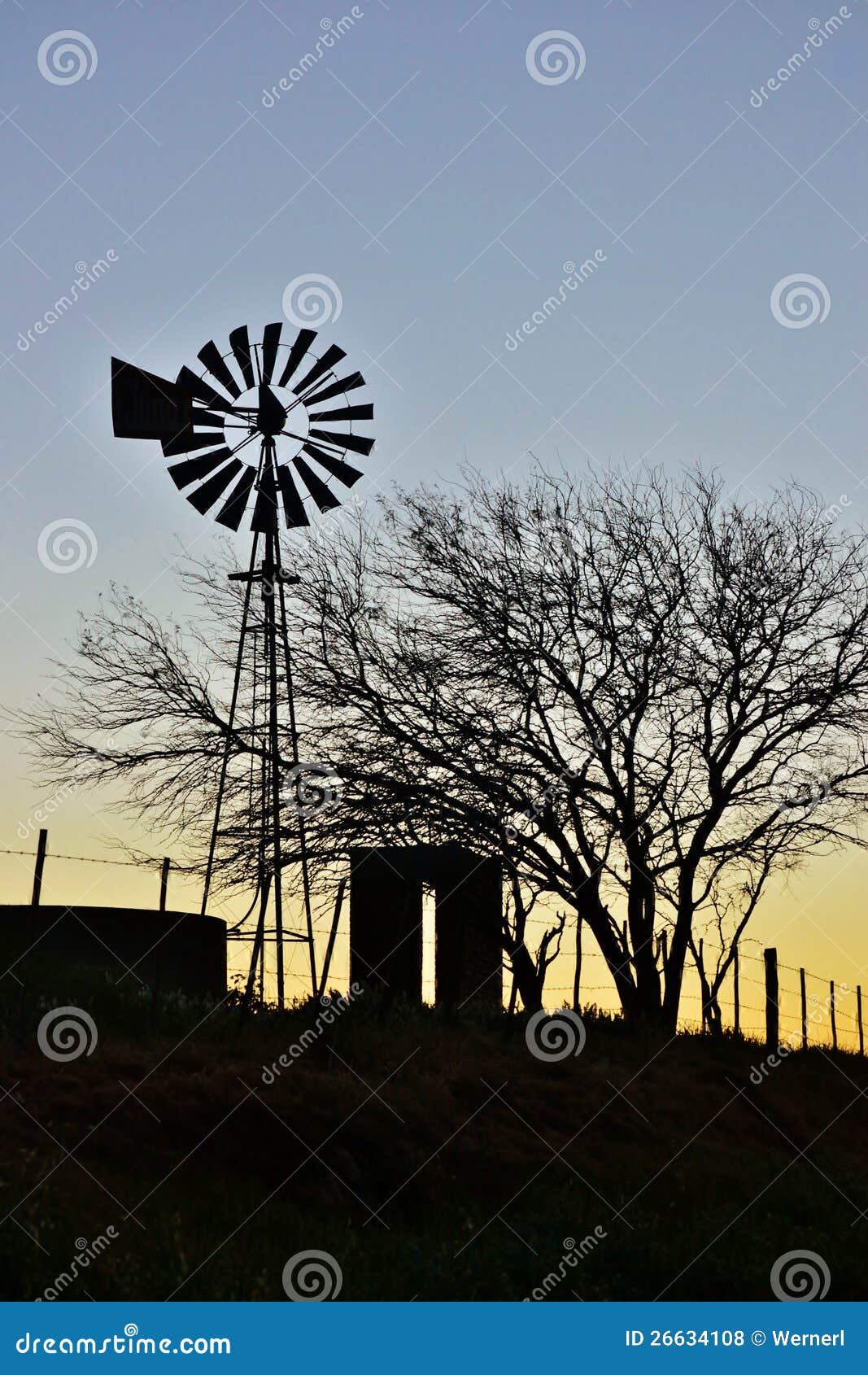 Landscape with windmill water pump on a swartland farm south africa.