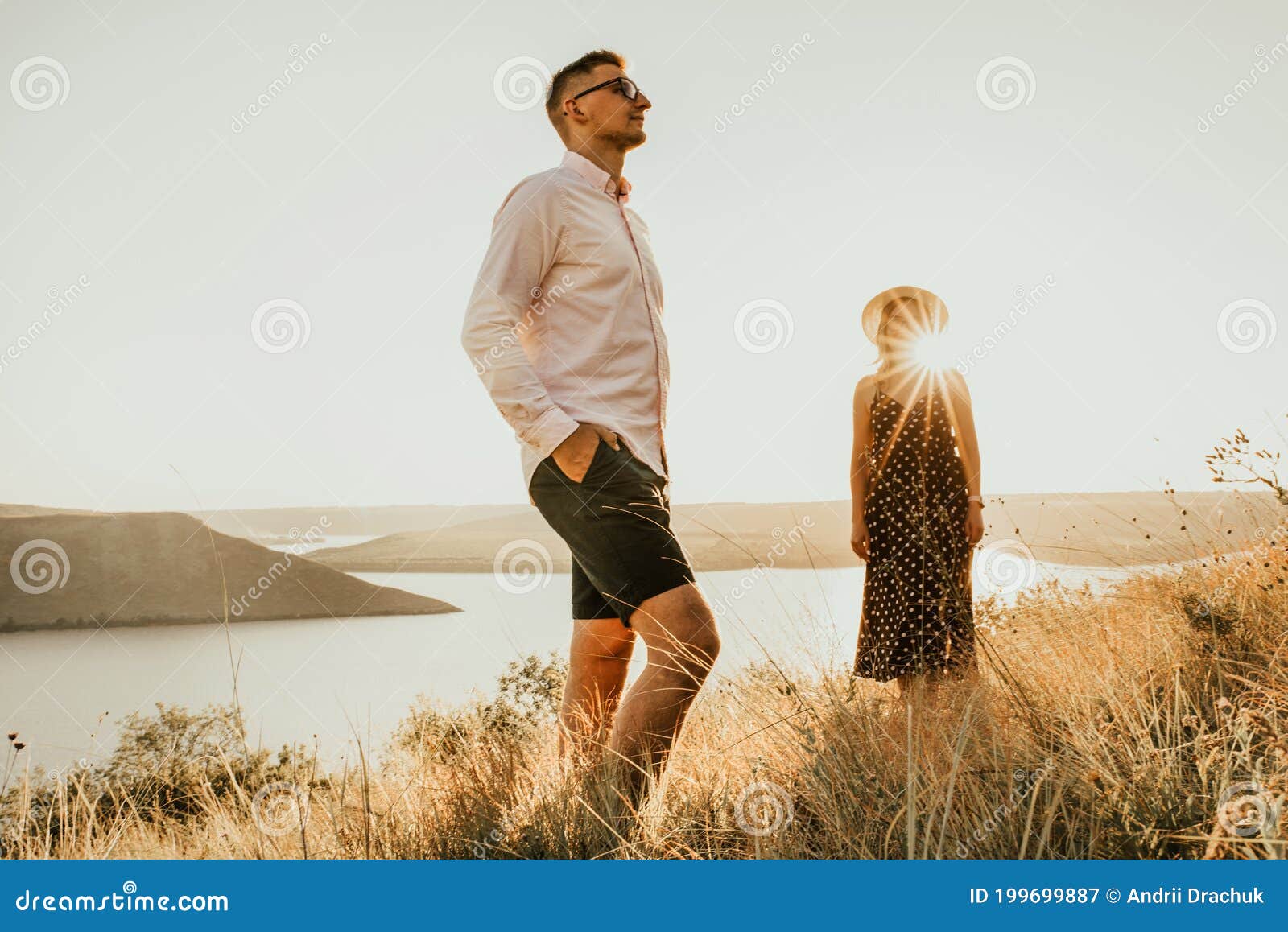 Woman Behind Man In Rays Of Setting Sun In Summer Stock Image Image