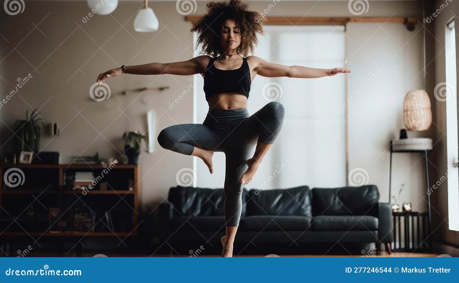 A Woman Balances On One Leg With The Other Lifted Behind Her Arms