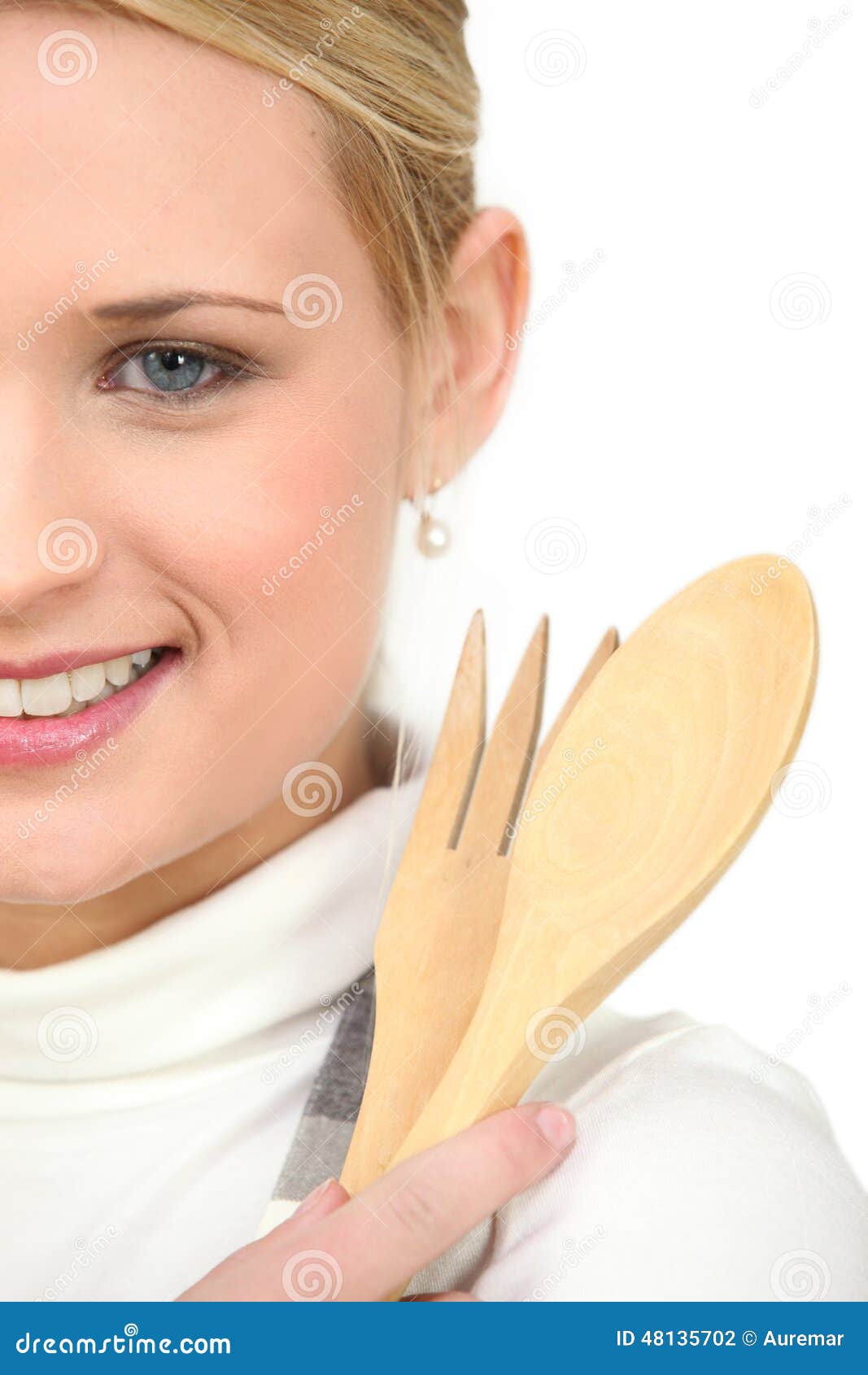 Woman holding wooden spoon - woman-holding-wooden-spoon-fork-48135702