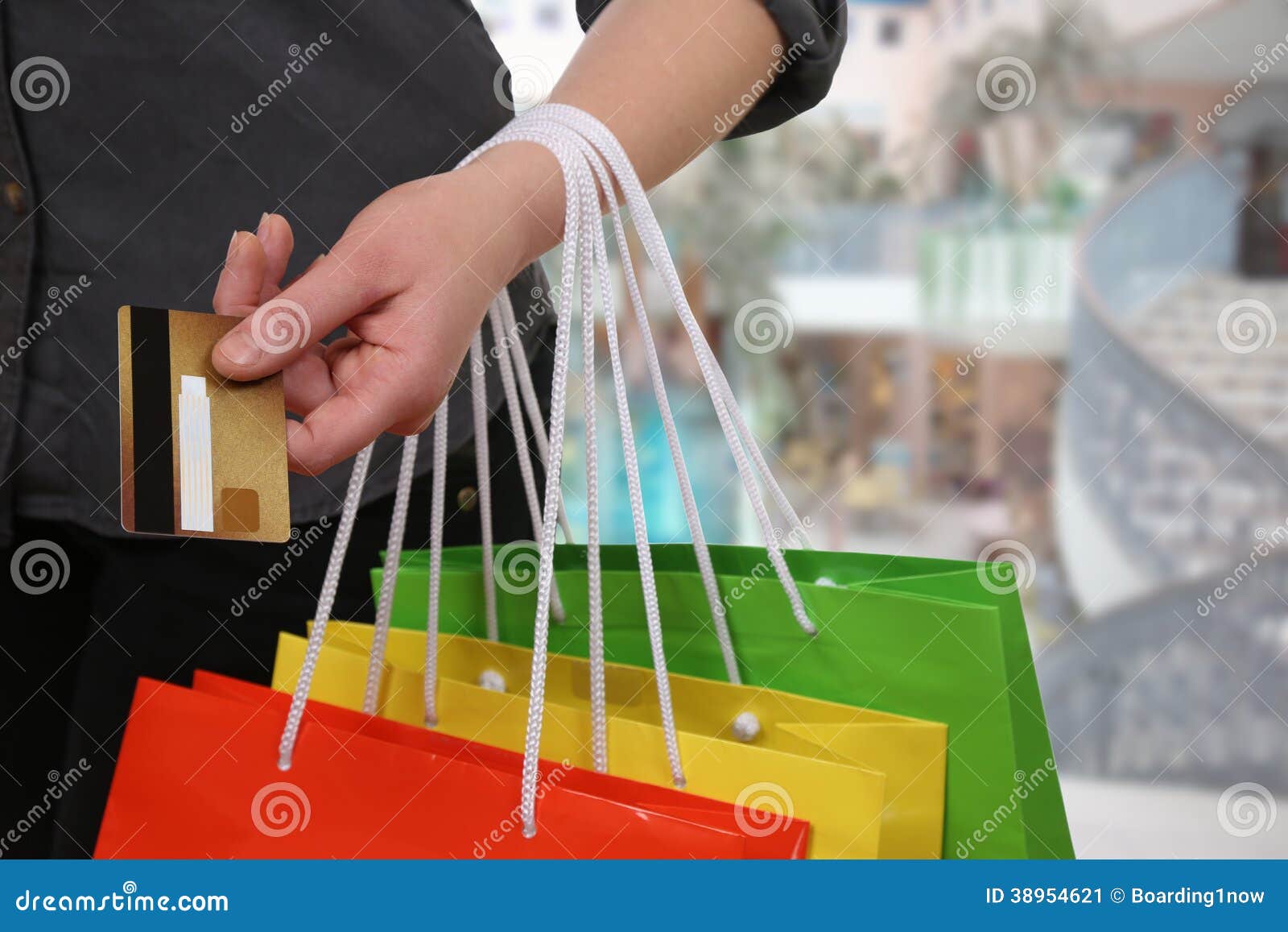 Beautiful Hispanic Woman Paying With A Credit Card At A Clothing
