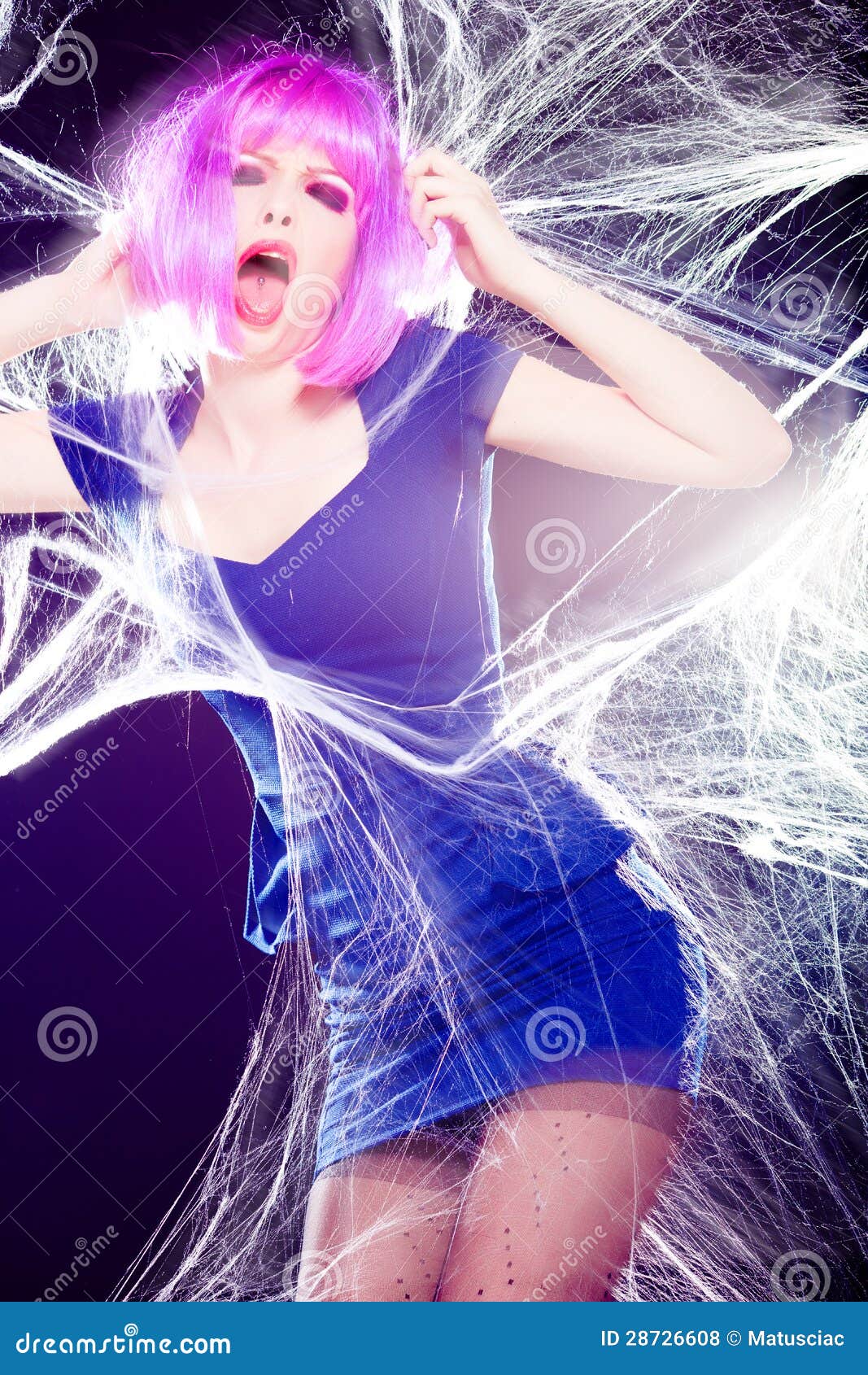 Woman With Purple Wig And Intense Make Up Trapped In A Spider Web Screaming Royalty Free Stock