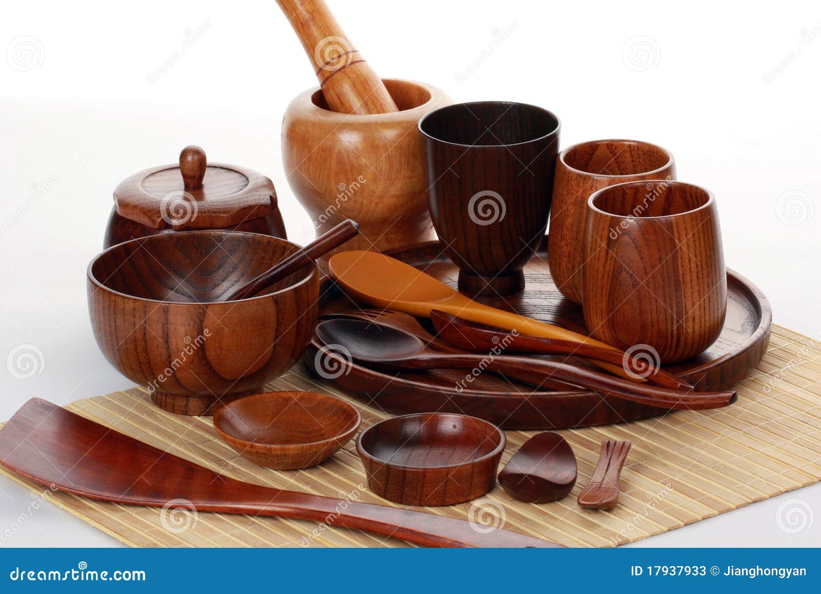 Wood craft (cups, bowl, spoons, scoops) on white background.