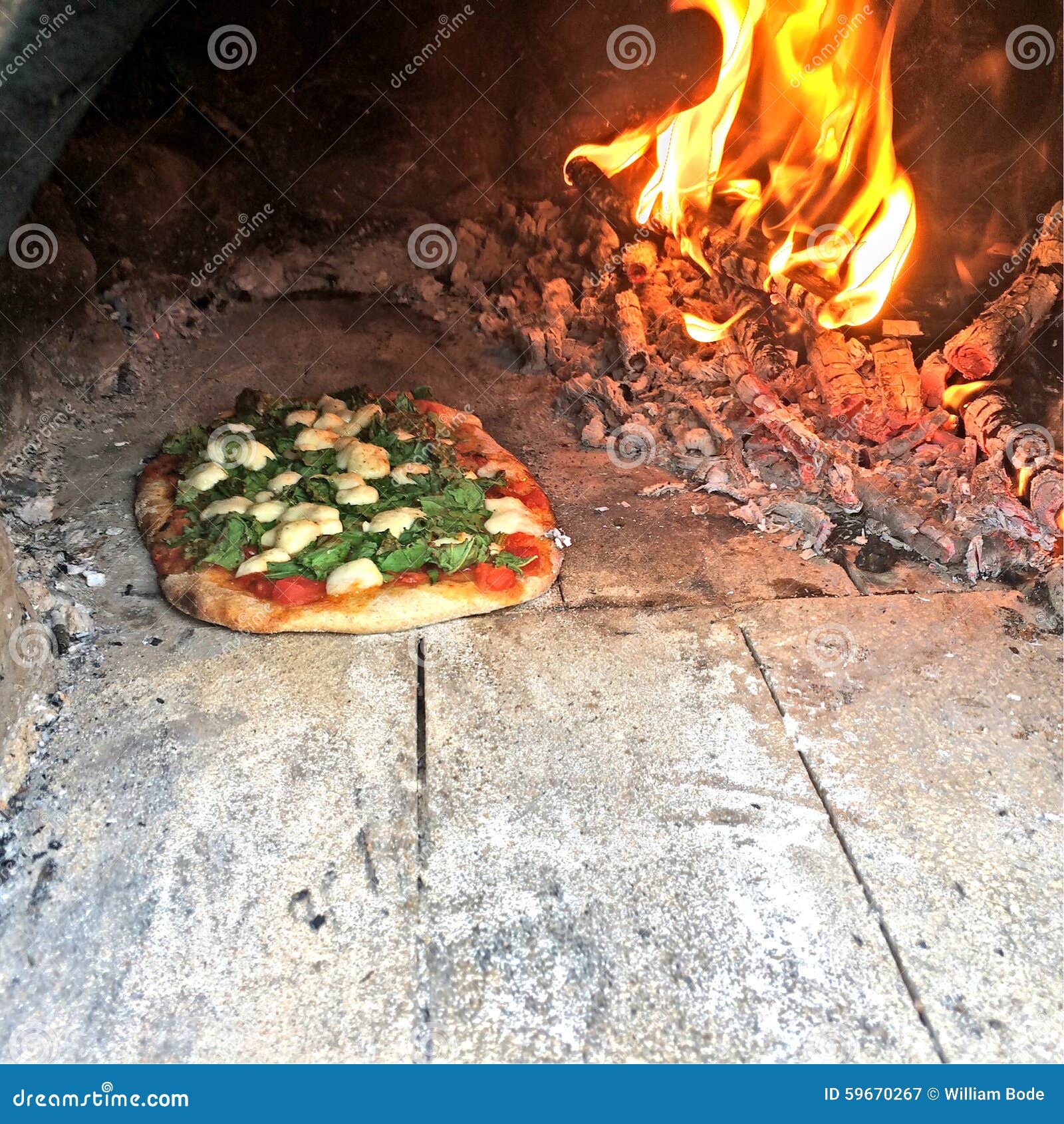 Artisan wood fired pizza baked in a clay cob earthen oven.