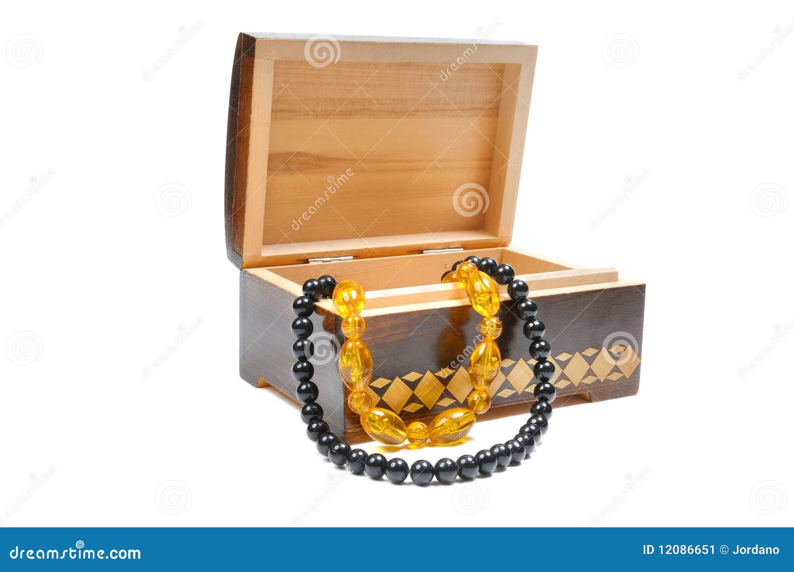 Wooden box with jewelry on a white background