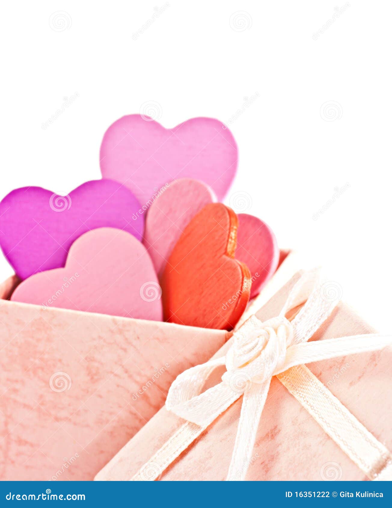 Wooden heart-shaped pink color Gift Box on the white background. Macro 