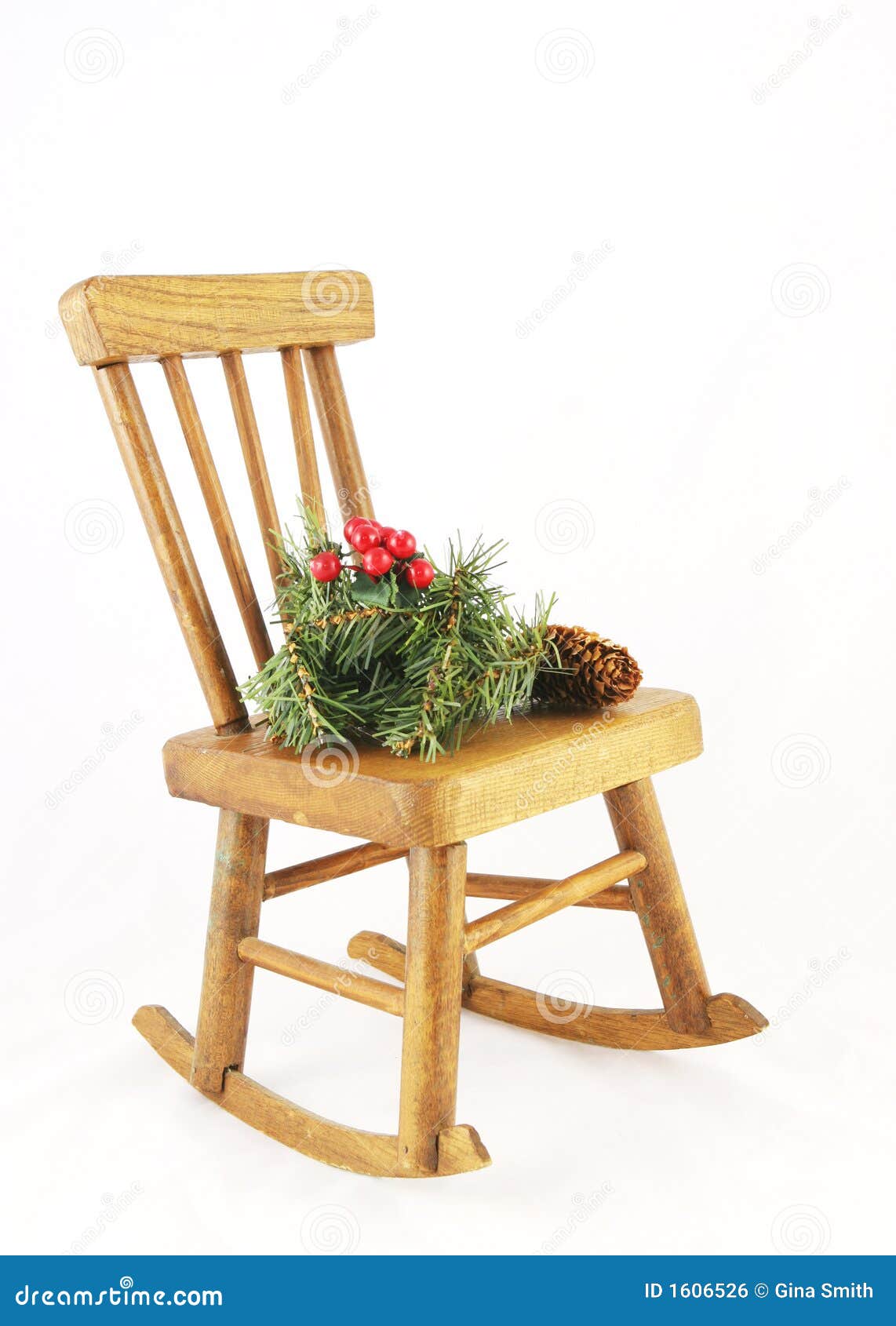 Christmas decorations sitting on a wooden rocking chair - isolated.