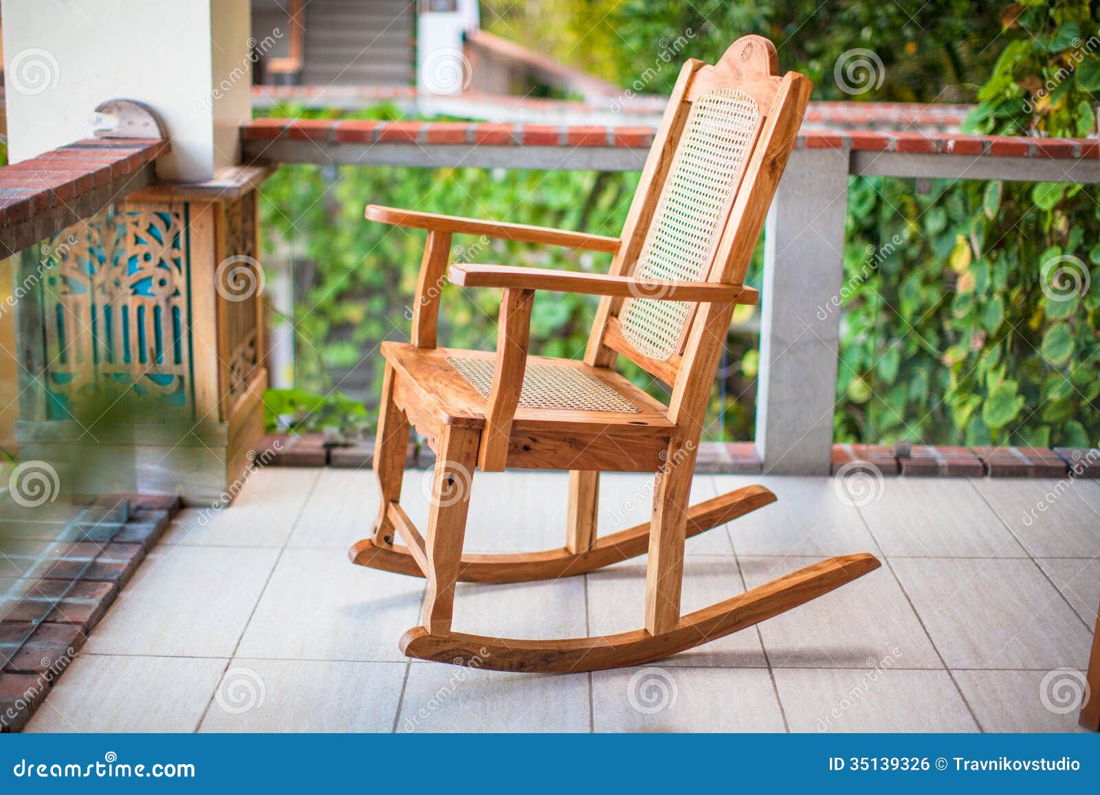 Wooden rocking chair on the terrace of an exotic hotel. See my other 