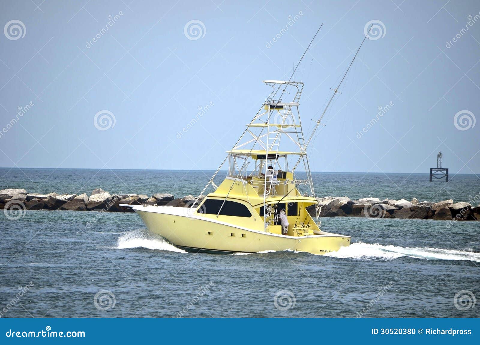 sport fishing boat headed out to the open ocean speeding through ...