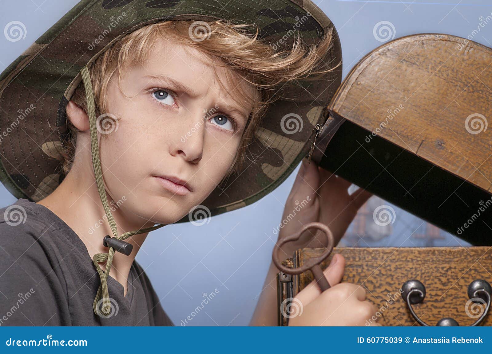 Young boy and a <b>treasure chest</b> Royalty Free Stock Images - young-boy-treasure-chest-traveler-hat-opening-holding-key-looking-thoughtfully-60775039