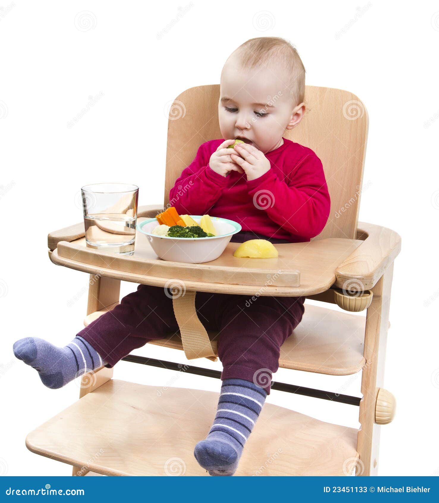 shirt eating vegetables in wooden chair. Isolated on white background