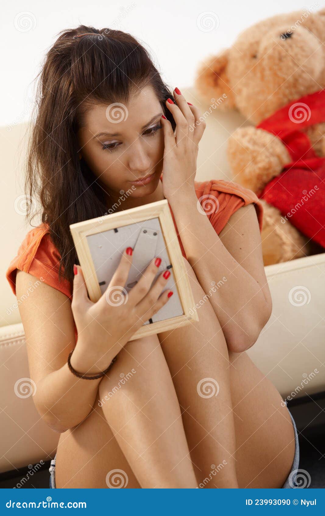 Young Girl Looking At Photo Crying Stock Photo Image