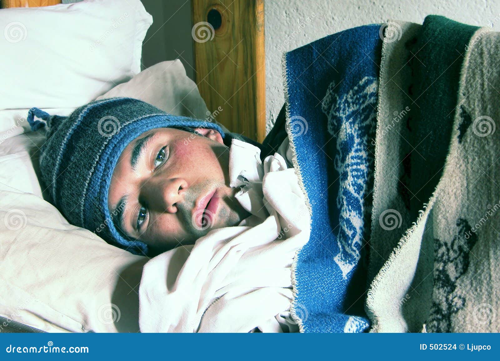 Man With A Cold Man in a bed feeling cold