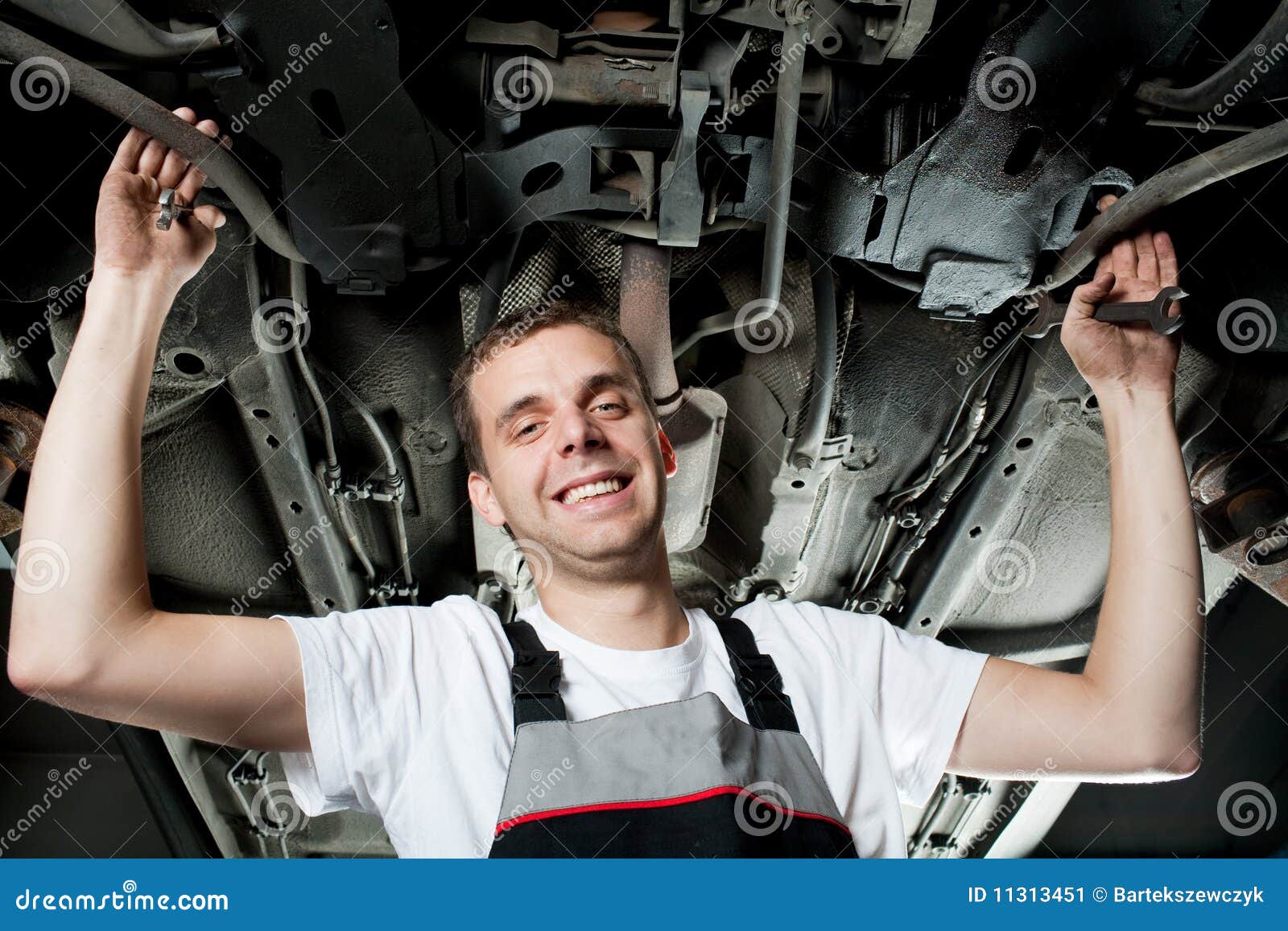 Young Mechanic Working Below The Car In Garage Stock Image - Image ...