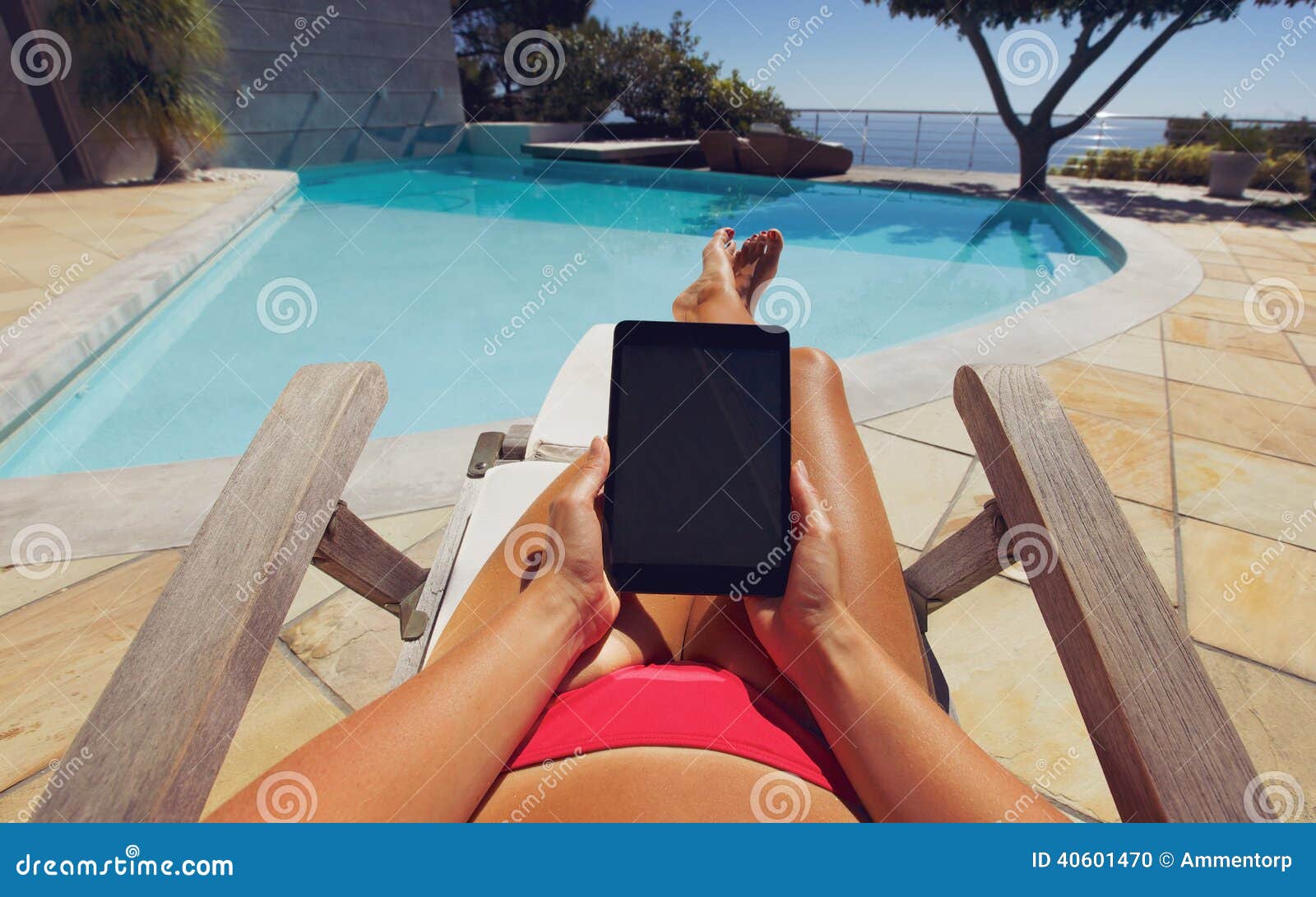 Young Woman Using A Tablet PC Near The Pool Stock Photo Image 40601470