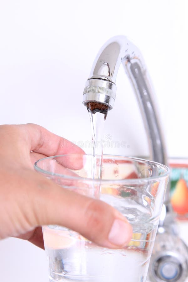 Переполнение жидкостью. Горячая вода стоковые фото. Water Glass hand tap. Running Water in the Kitchen.